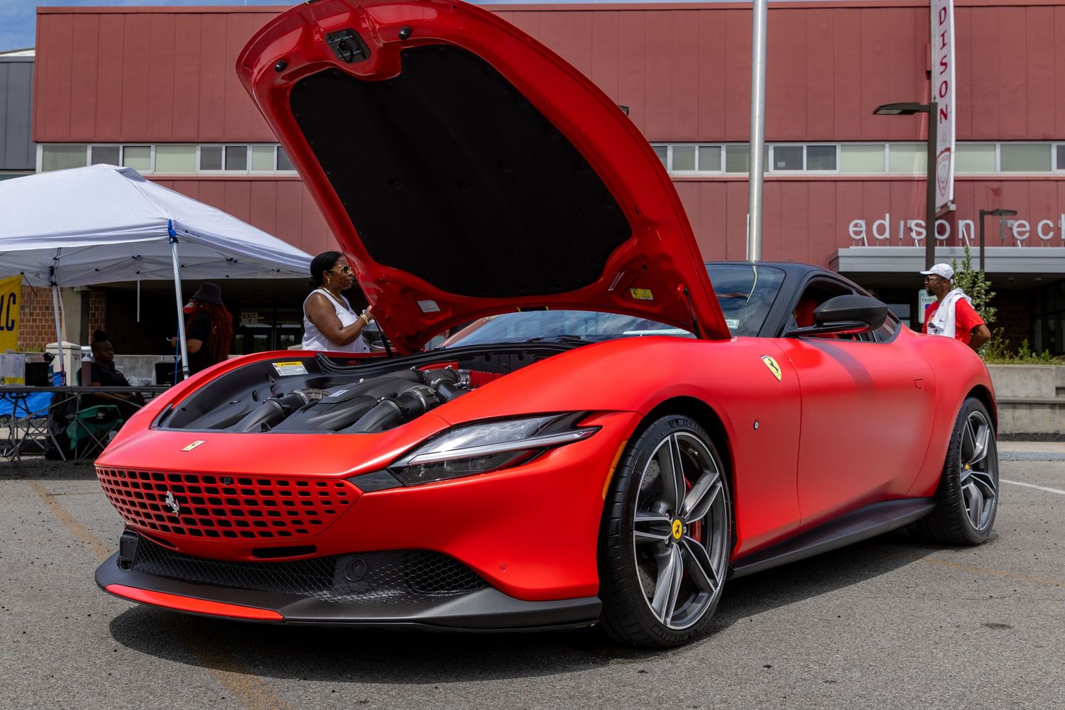 Red Ferrari SF90 Stradale supercar showcases its sleek profile and distinctive bodywork during outdoor display.