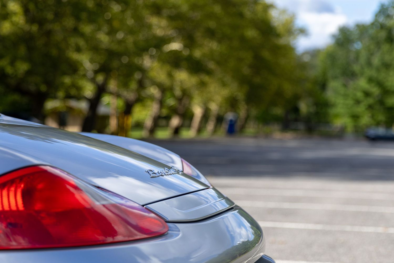 Close-up view of a red and silver luxury car's exterior body panels and sporty trim details.