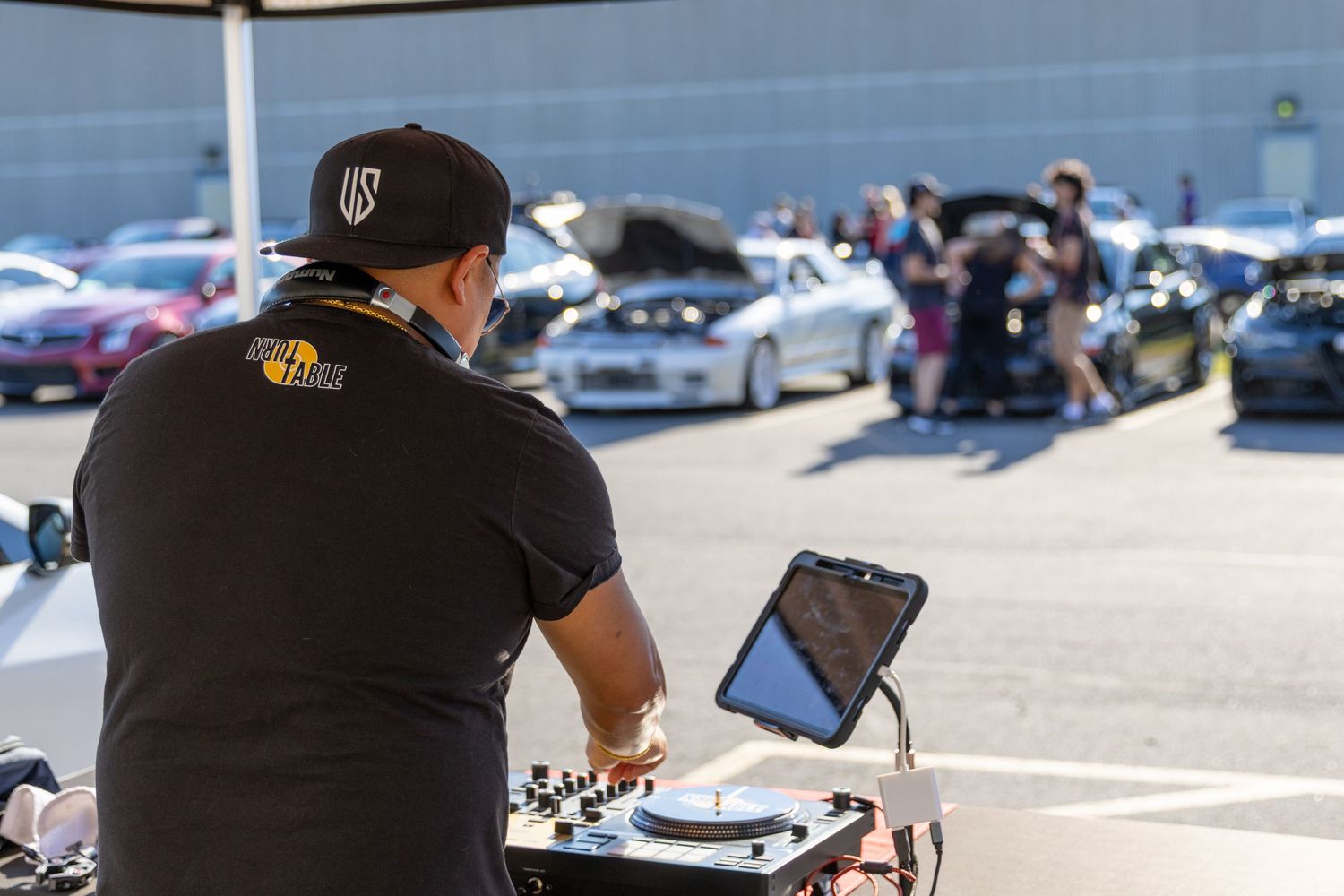Musicians perform live outdoor entertainment for spectators during a sunny day at a festival event.