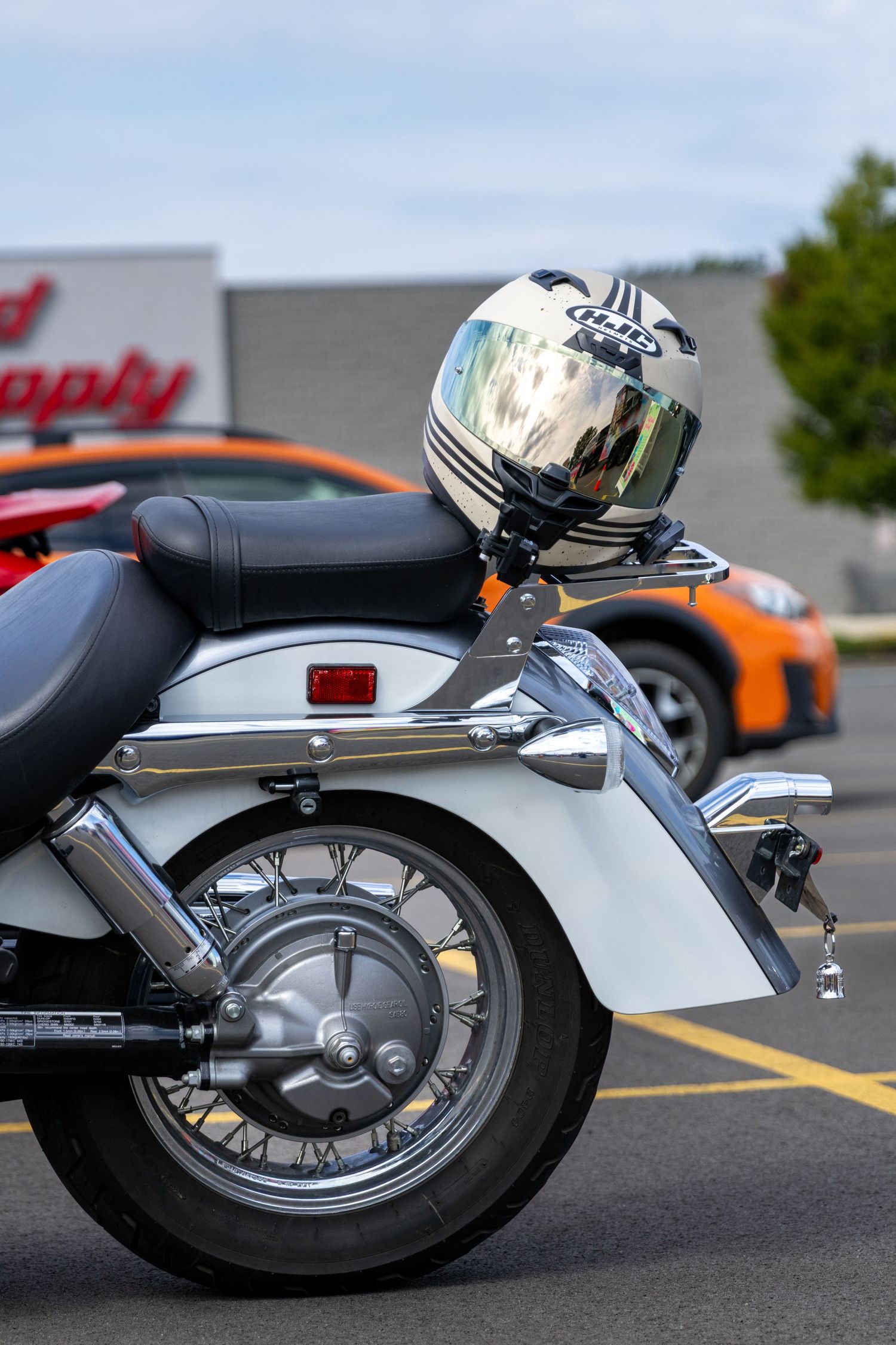 Series of close-up views showing chrome exhaust pipes and wheel details of a vintage BMW motorcycle.