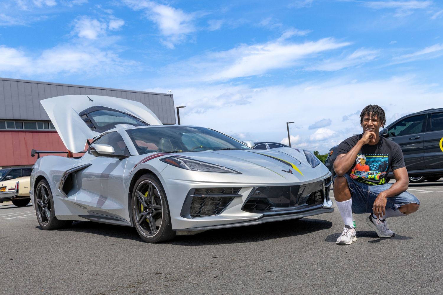 Low angle view of a silver sports car with aggressive styling under blue skies.