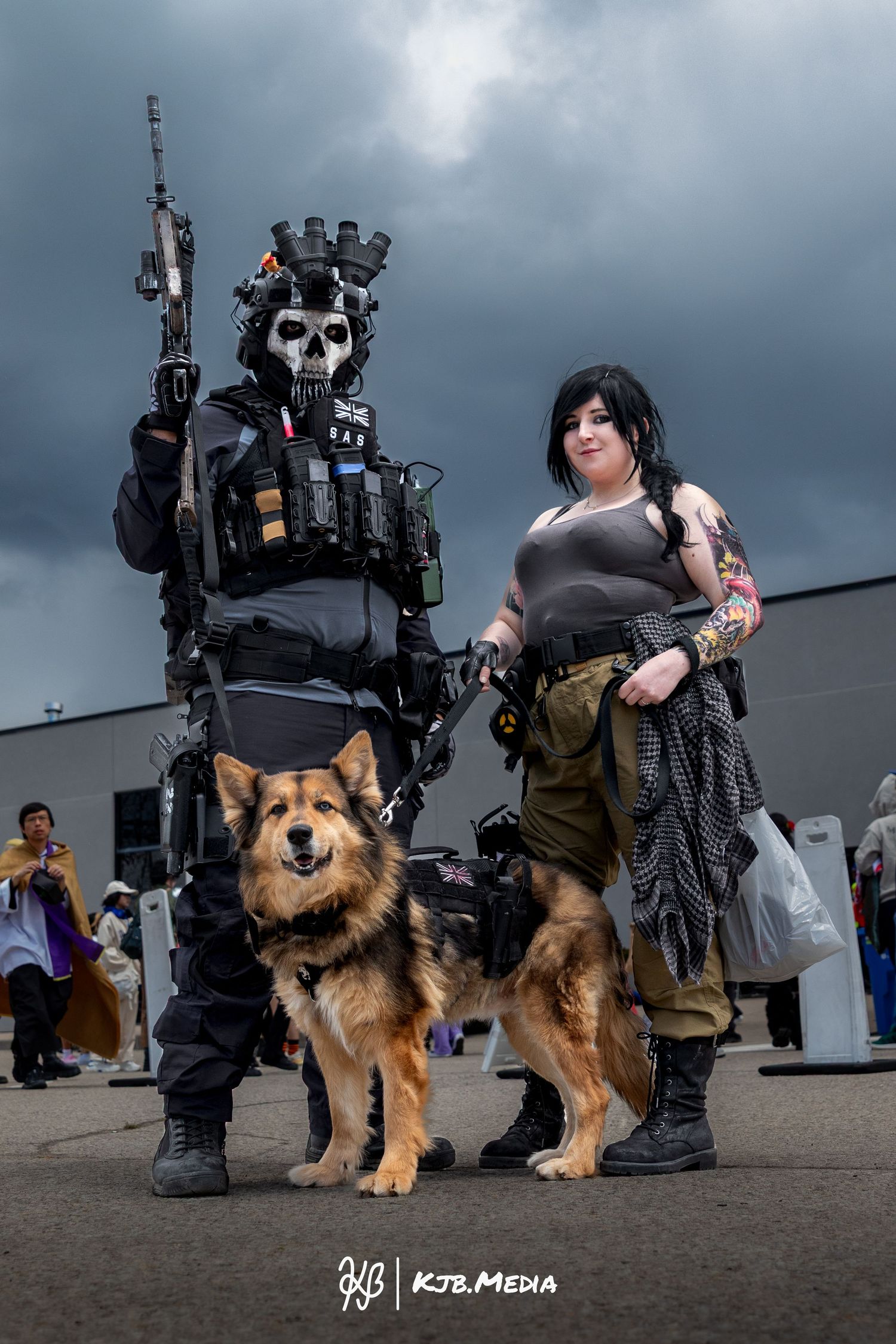 Cosplay photo featuring futuristic military-style outfits and a German Shepherd dog against a cloudy background.