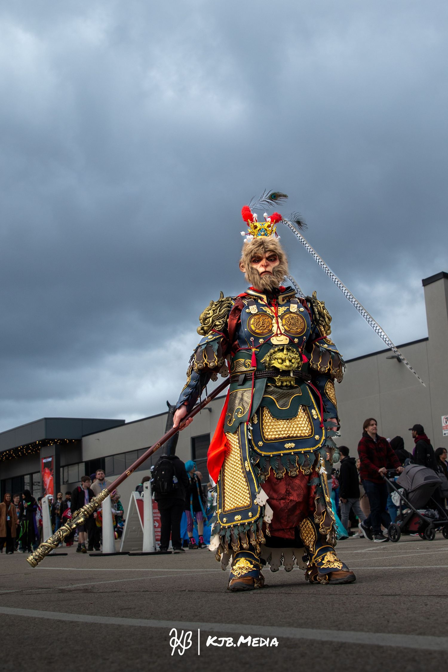 Elaborate samurai warrior cosplay with ornate golden armor and decorative headpiece.