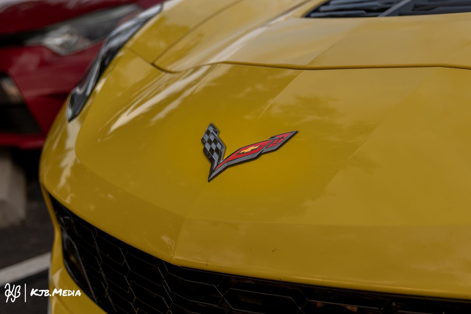 Close-up detail shots of a yellow Chevrolet Corvette's hood and front end.