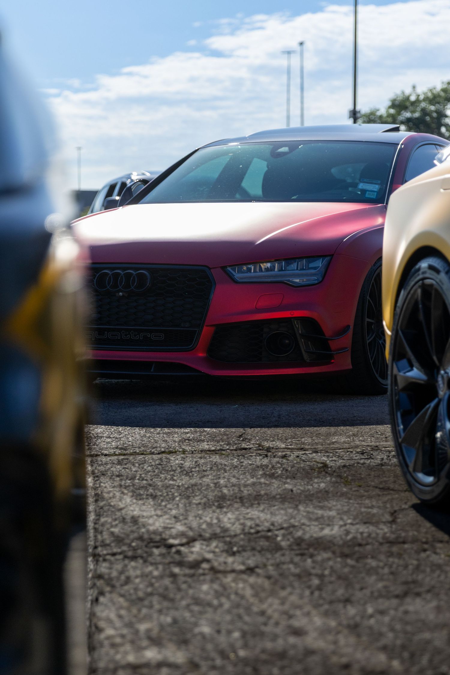Red Audi sports car photographed at a dramatic low angle.