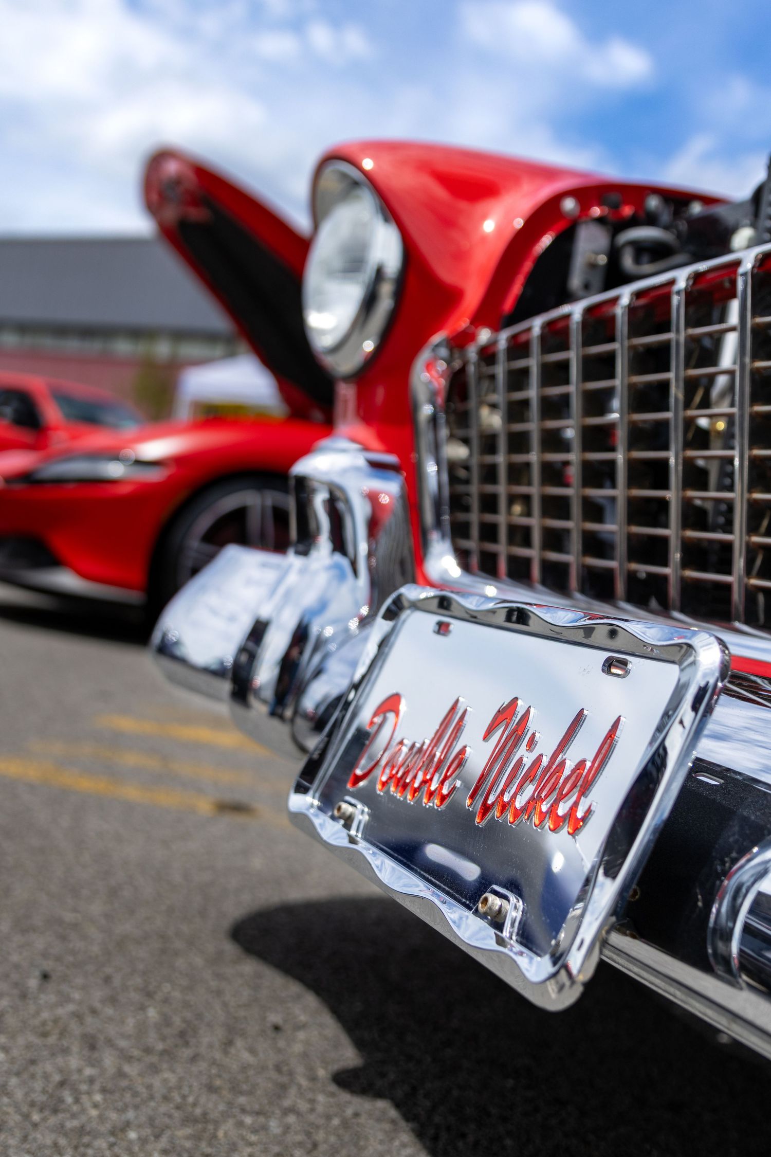Close-up sequence of chrome 'Impala' script badging on a classic red car.