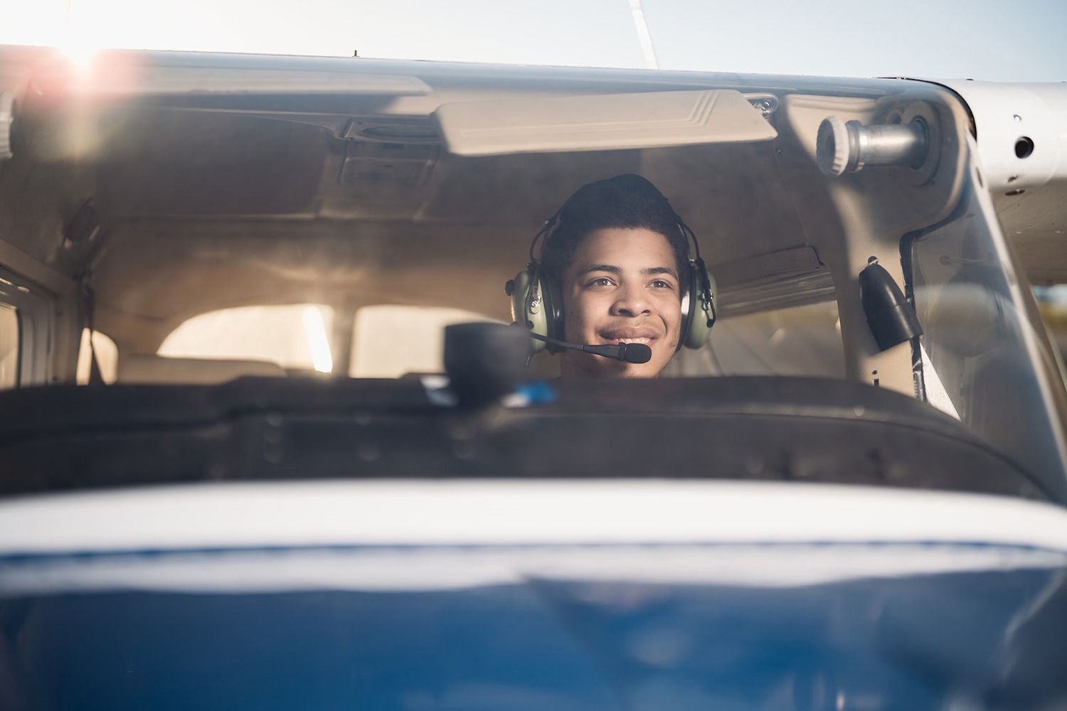 View through cockpit window of small private aircraft during flight.