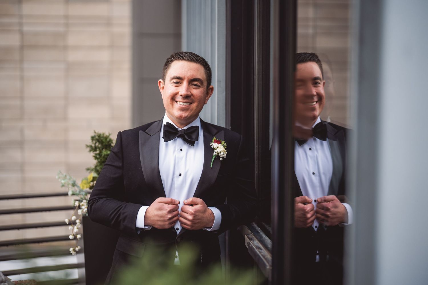 A tuxedo-clad black and white portrait series showing different smiling expressions.