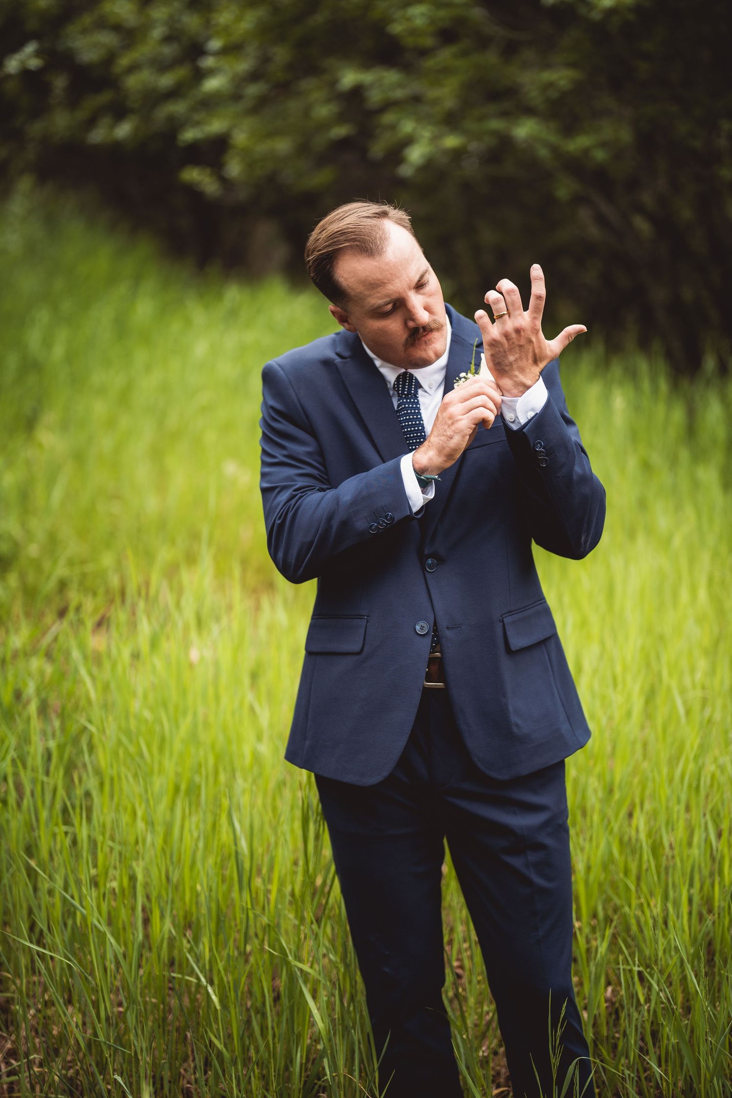 Playful wedding portraits showing animated gestures in an outdoor setting.