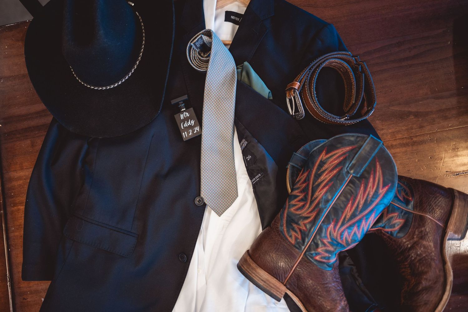 Detail shot of cowboy boots lined up against wooden paneling.