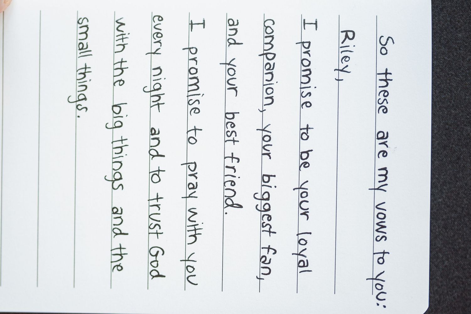 Handwritten text on lined paper shown in close-up detail.