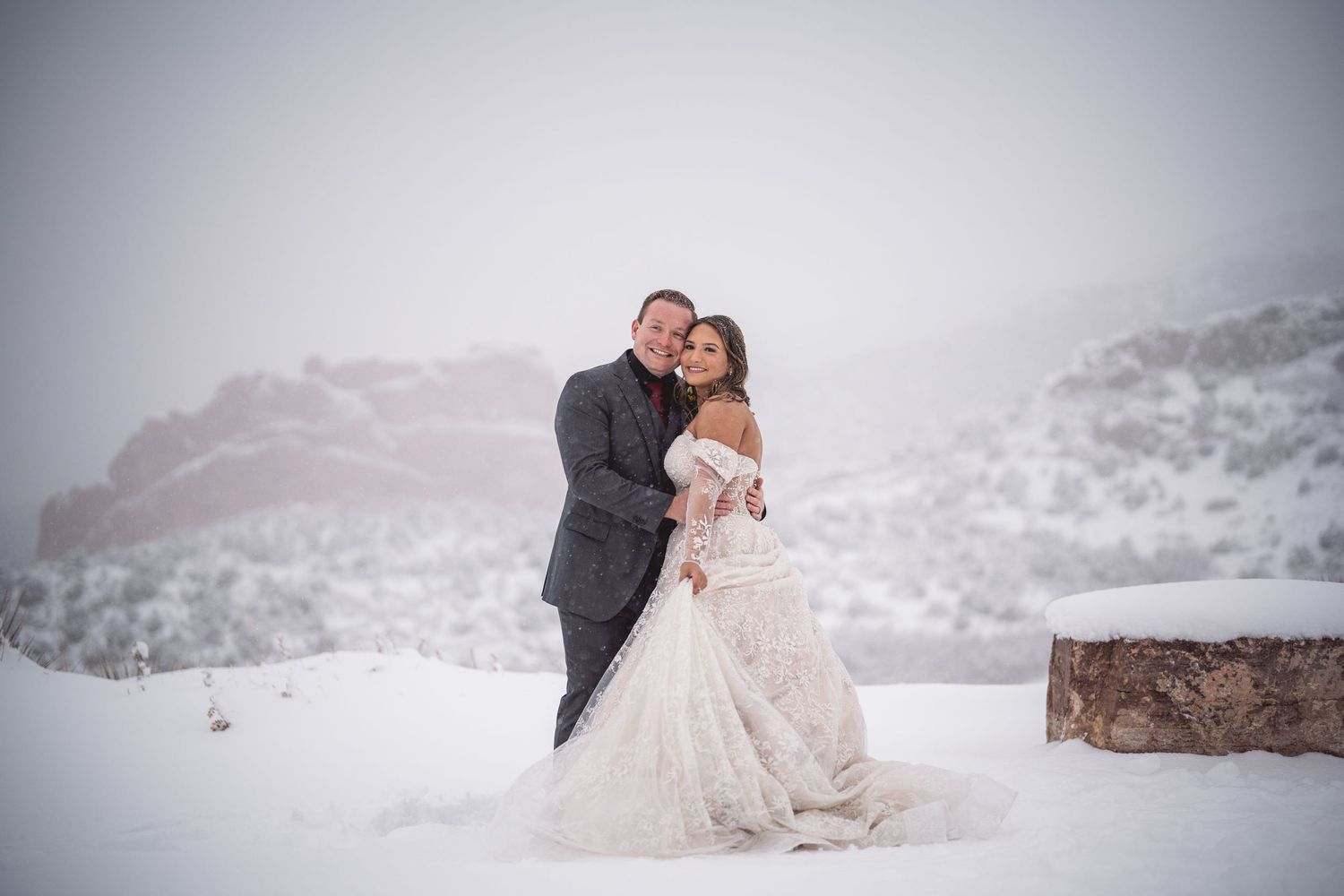 Romantic winter wedding photography session in a snowy mountain setting.