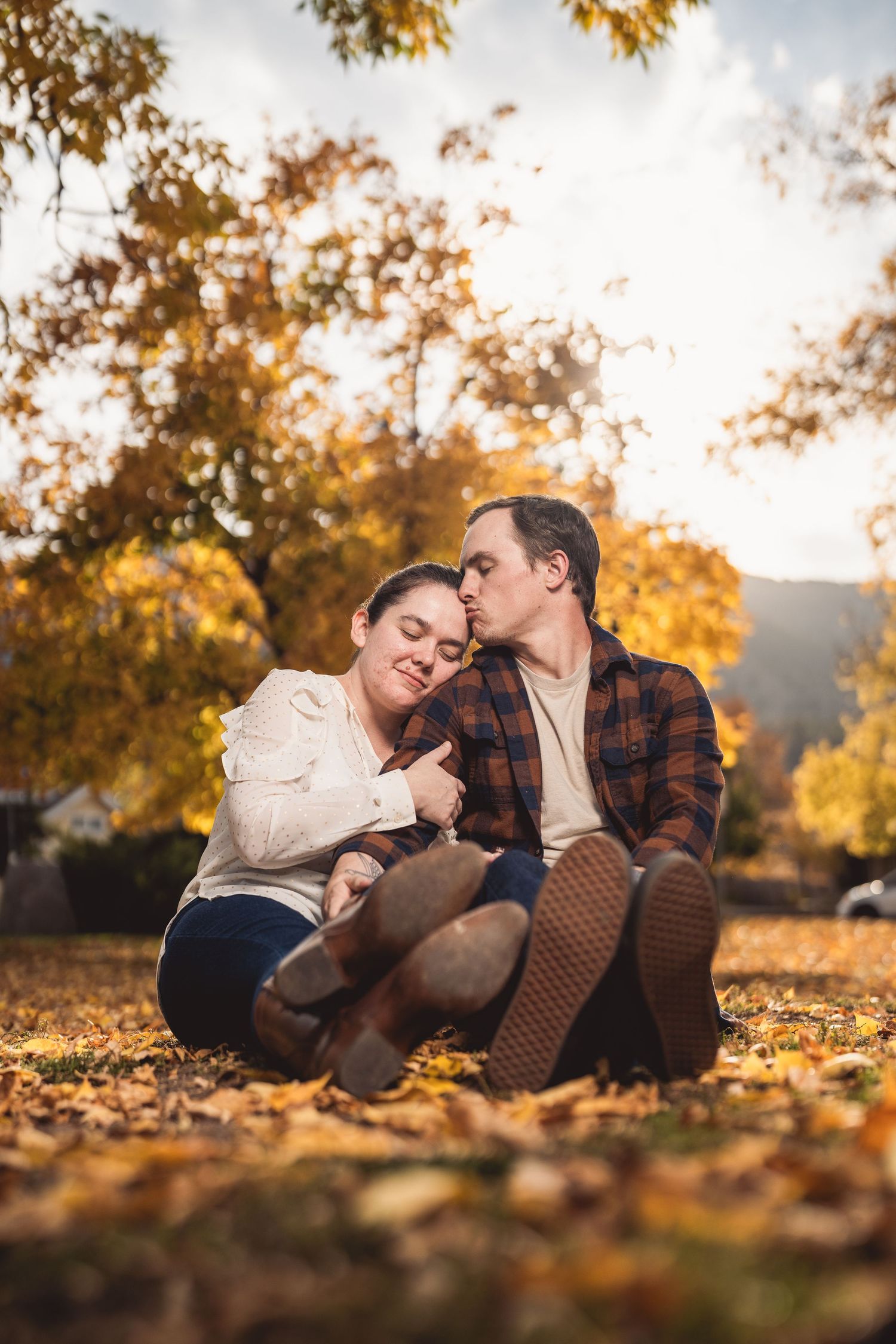 A romantic autumn photo shoot in fallen leaves with warm golden lighting.