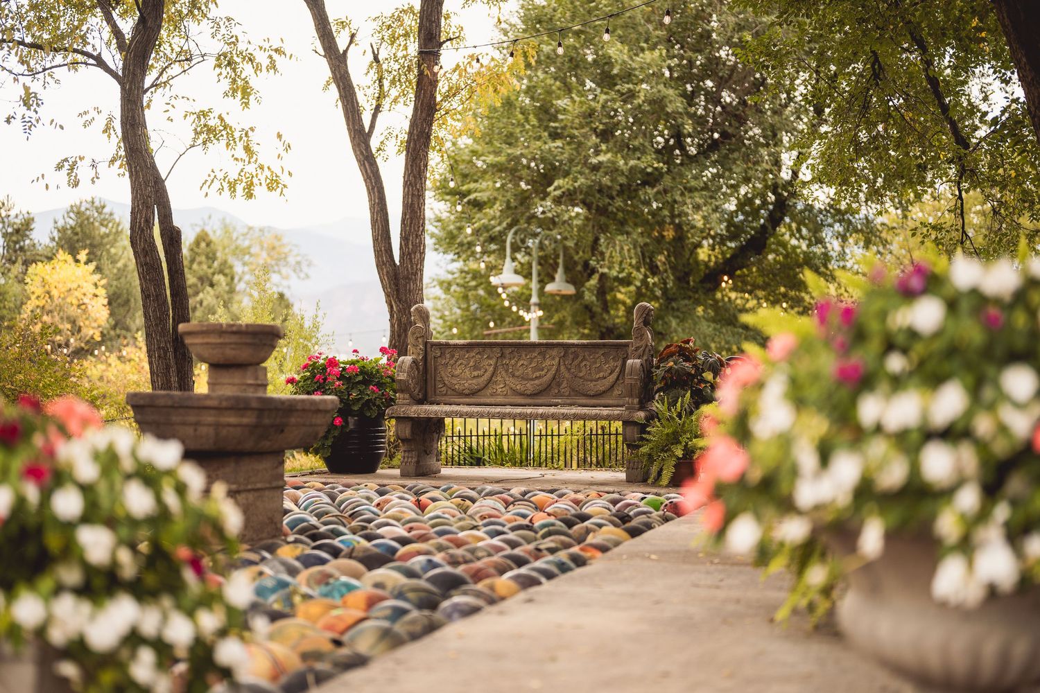Garden terrace with blooming flowers and trees creating a romantic outdoor setting.
