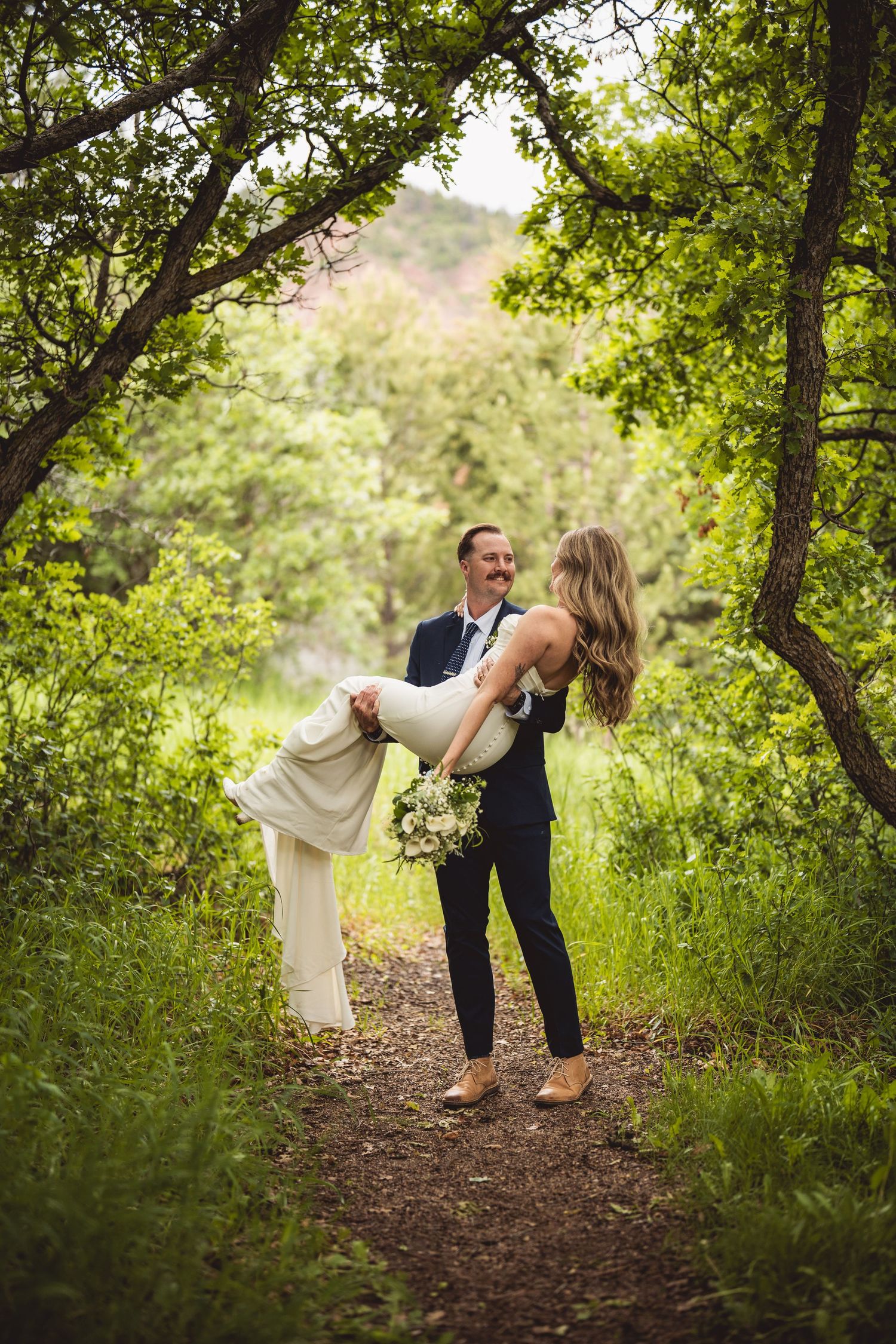 Dynamic wedding photo series showing couple's dance moves on woodland path.
