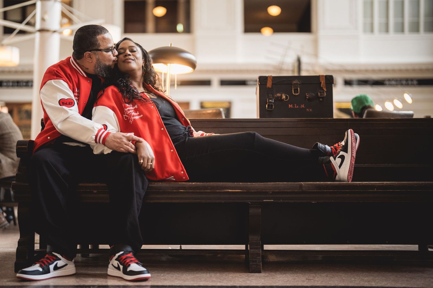 Romantic engagement session inside a historic train station with vintage architecture.