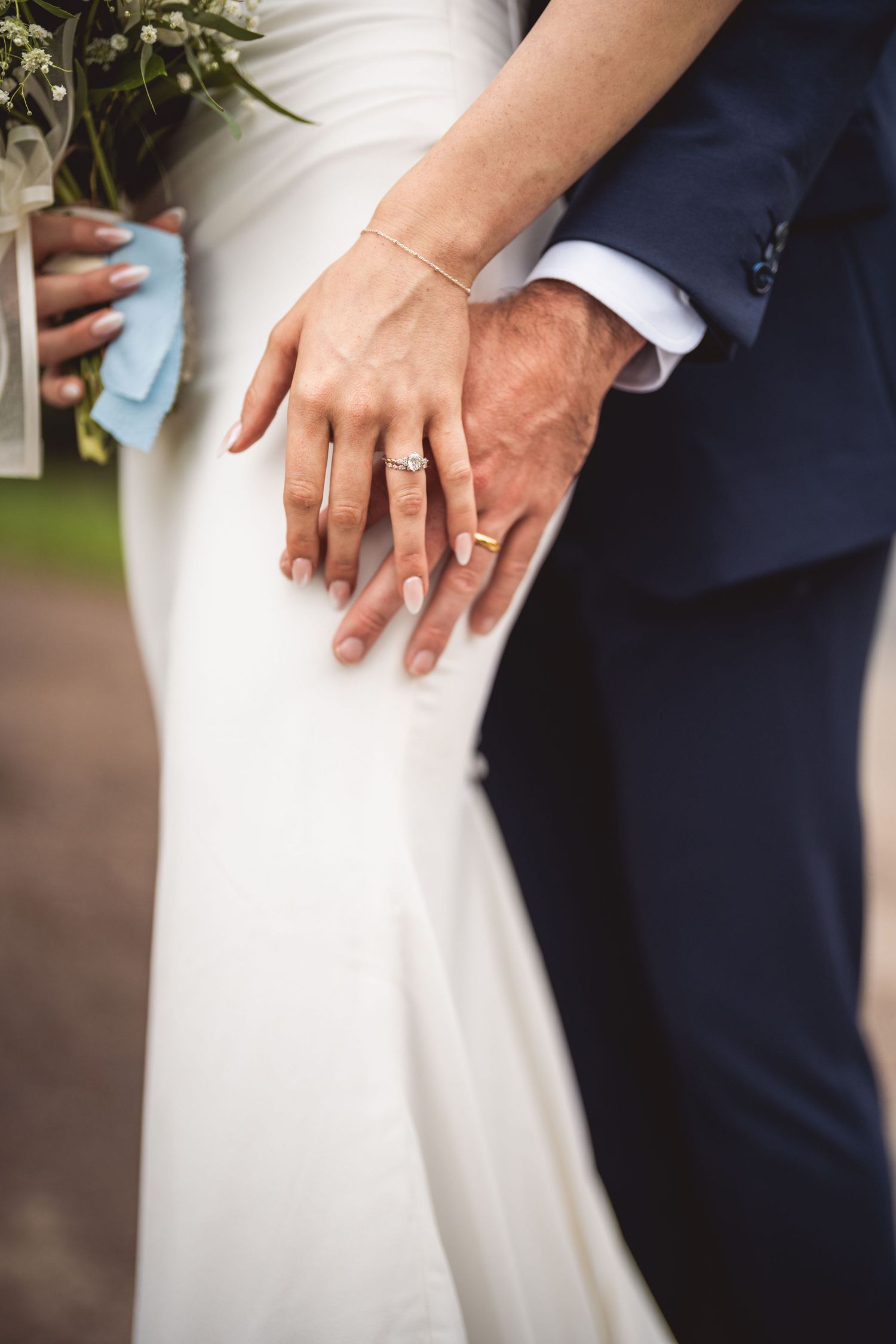 Close-up shots of wedding rings and hands against formal wedding attire.