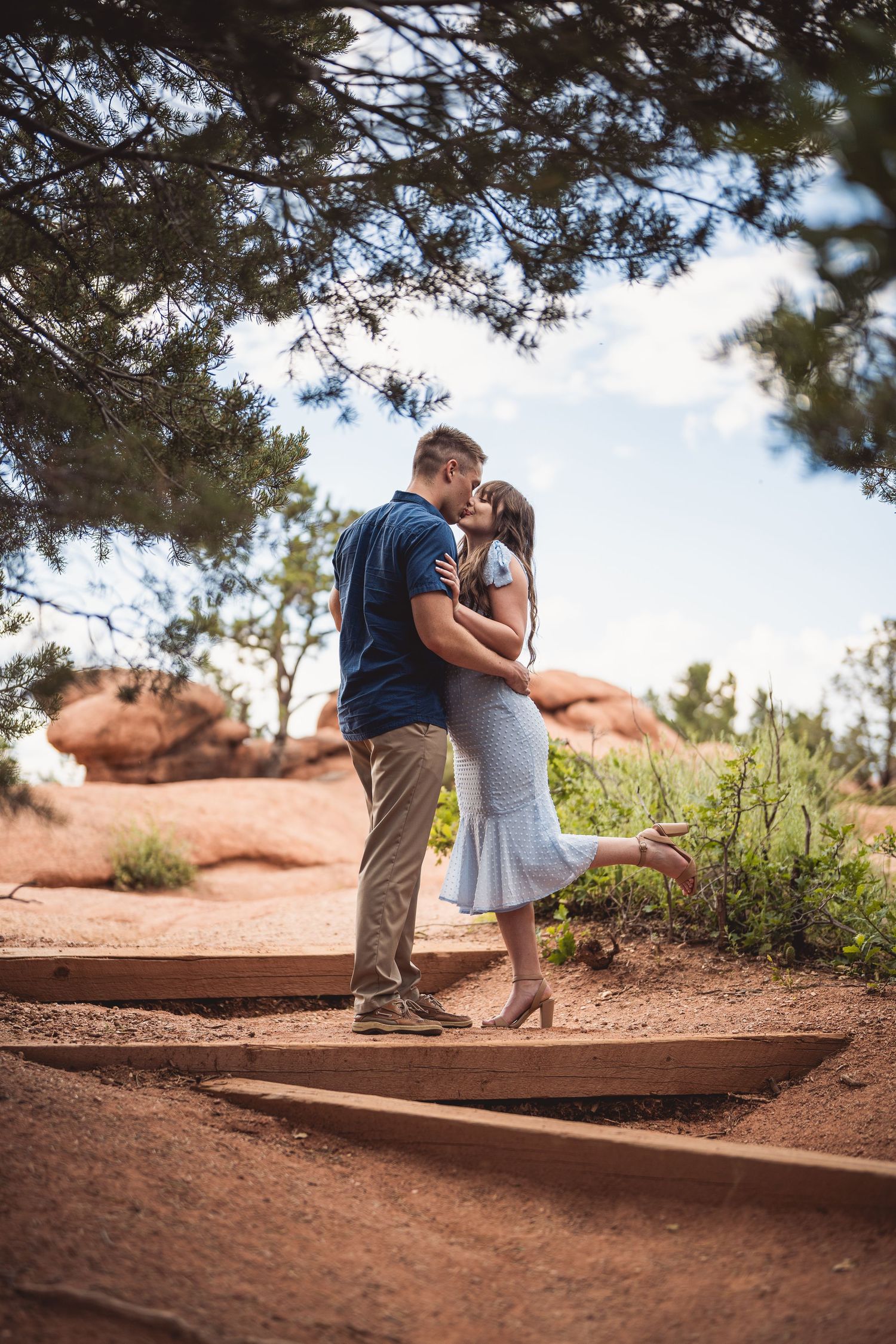 A romantic moment on rustic steps among the red rocks and pine trees.