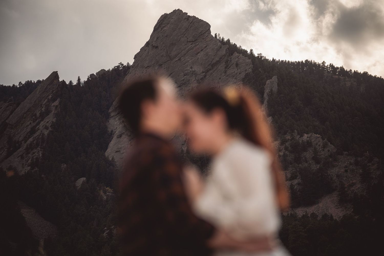 Dramatic mountain landscape provides backdrop for romantic outdoor photo session.