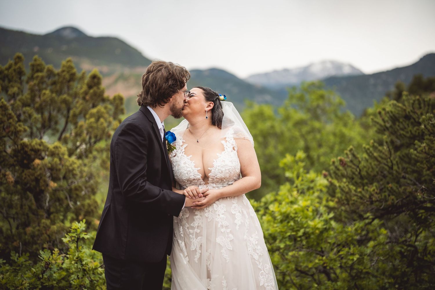 A candid wedding moment photographed with scenic mountain views in the background.