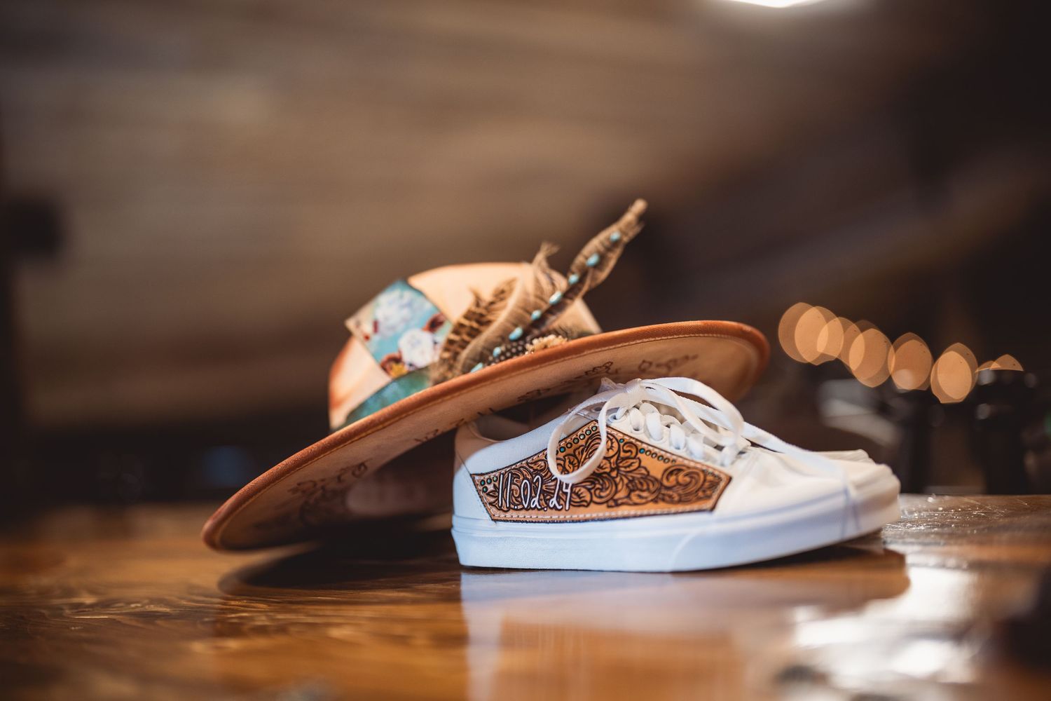 Custom decorated wedding shoes displayed on a wooden surface.