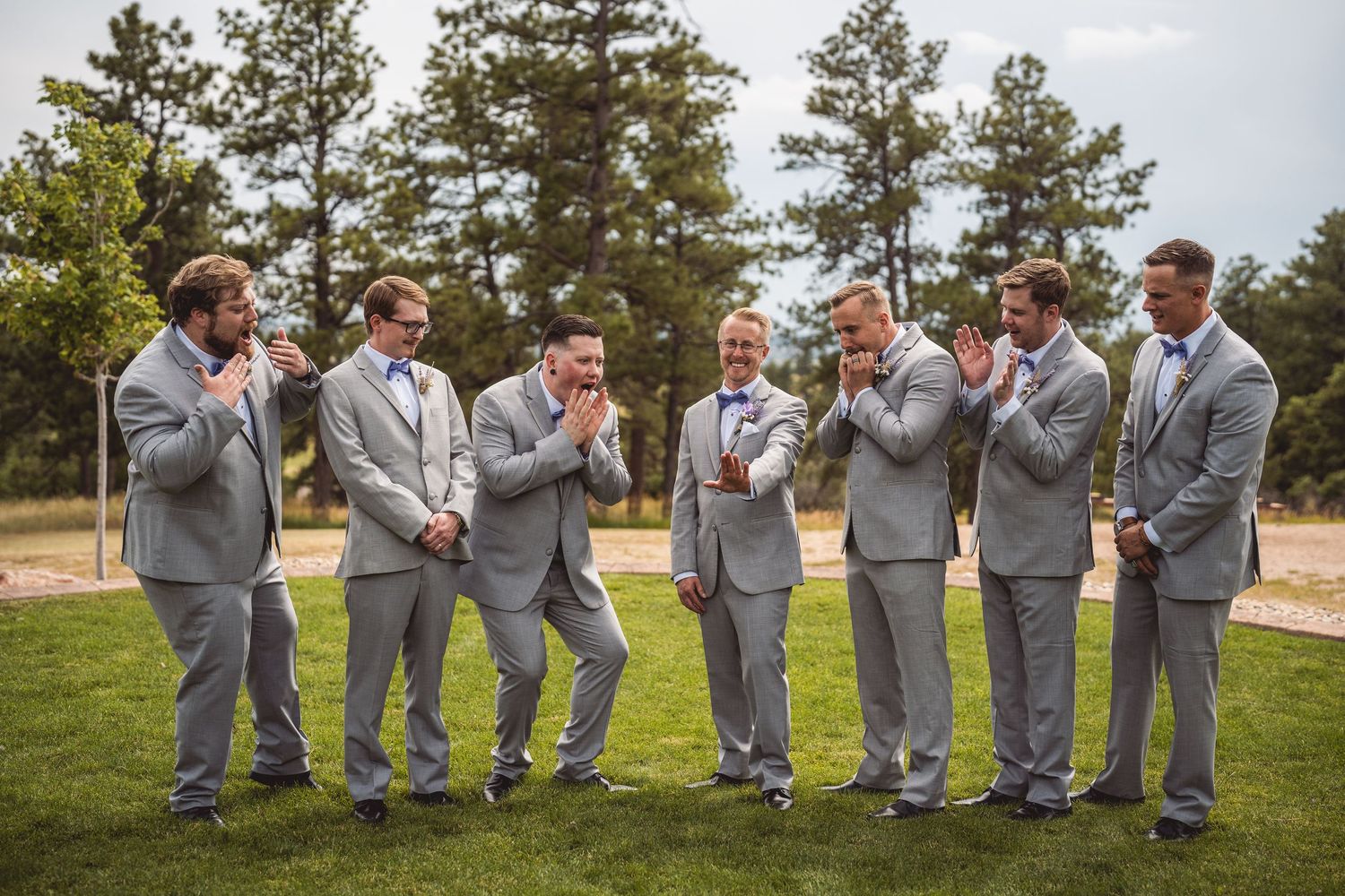 Groomsmen in matching gray suits pose playfully outdoors in a series of creative photo compositions.