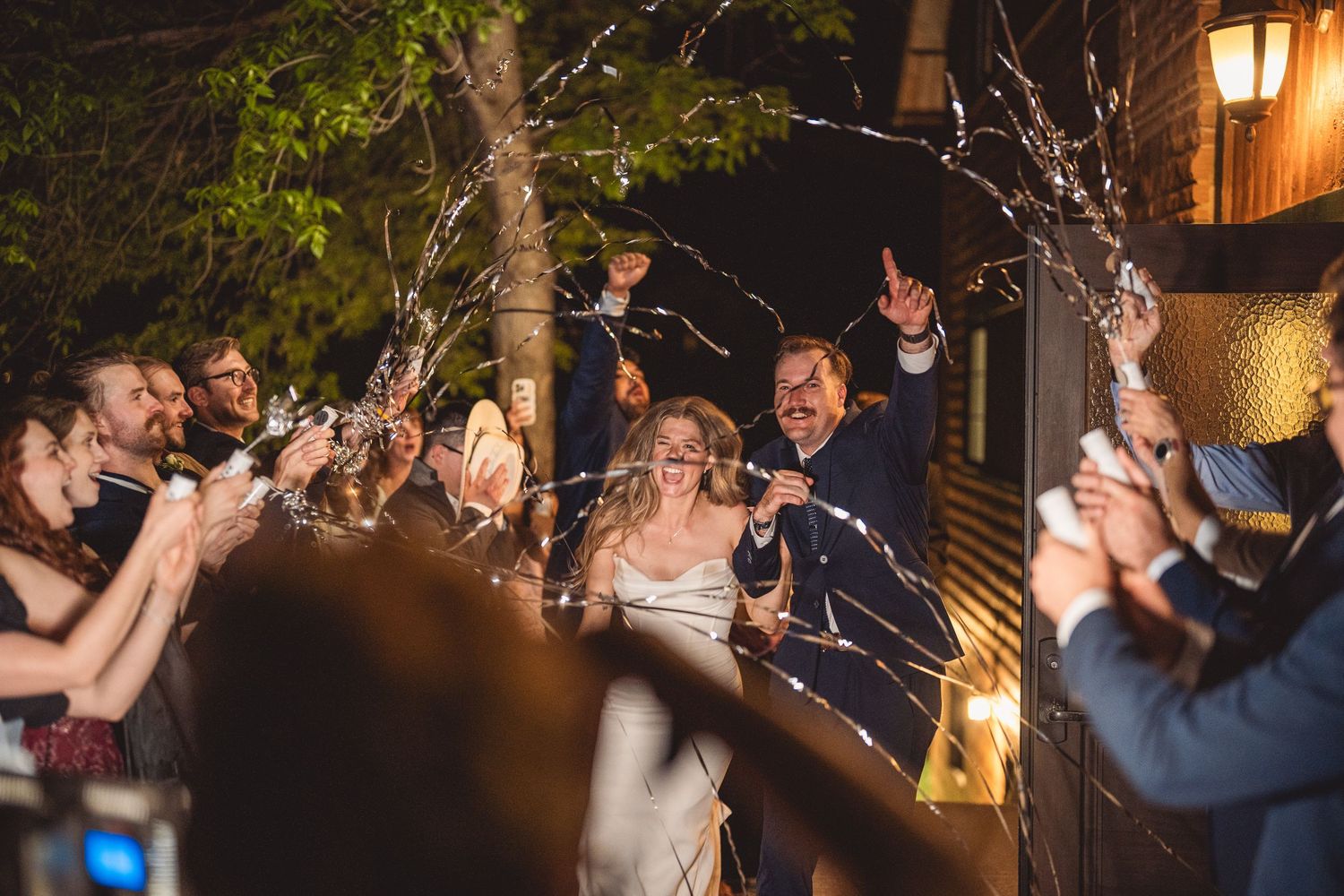 Wedding celebration at night with sparklers creating magical light trails.