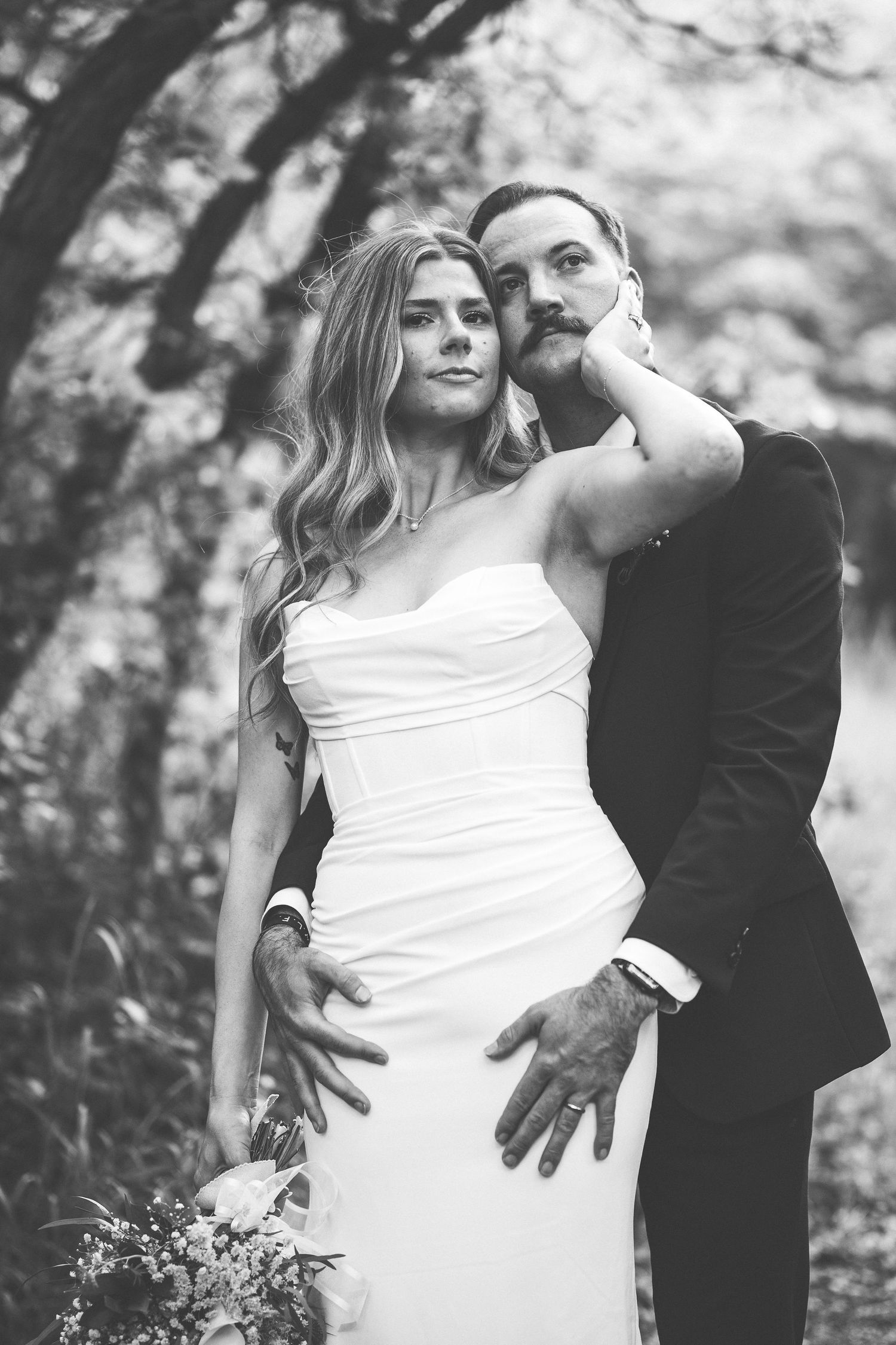 Black and white artistic wedding portraits showing intimate poses.