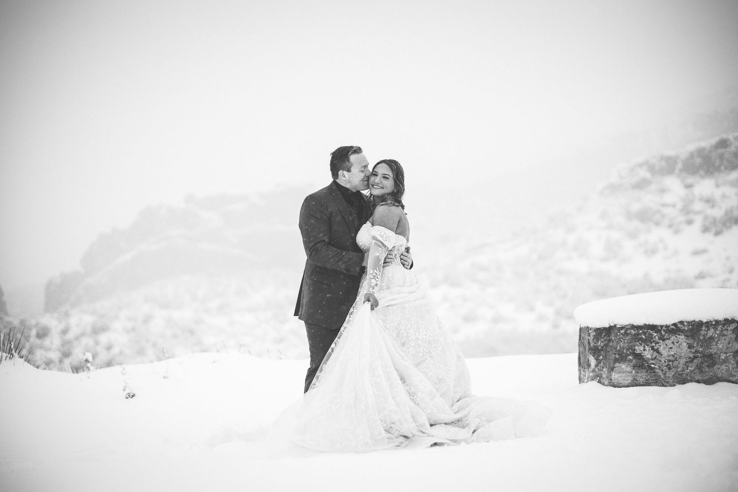 Snowy mountain wedding photoshoot with dramatic white landscape.
