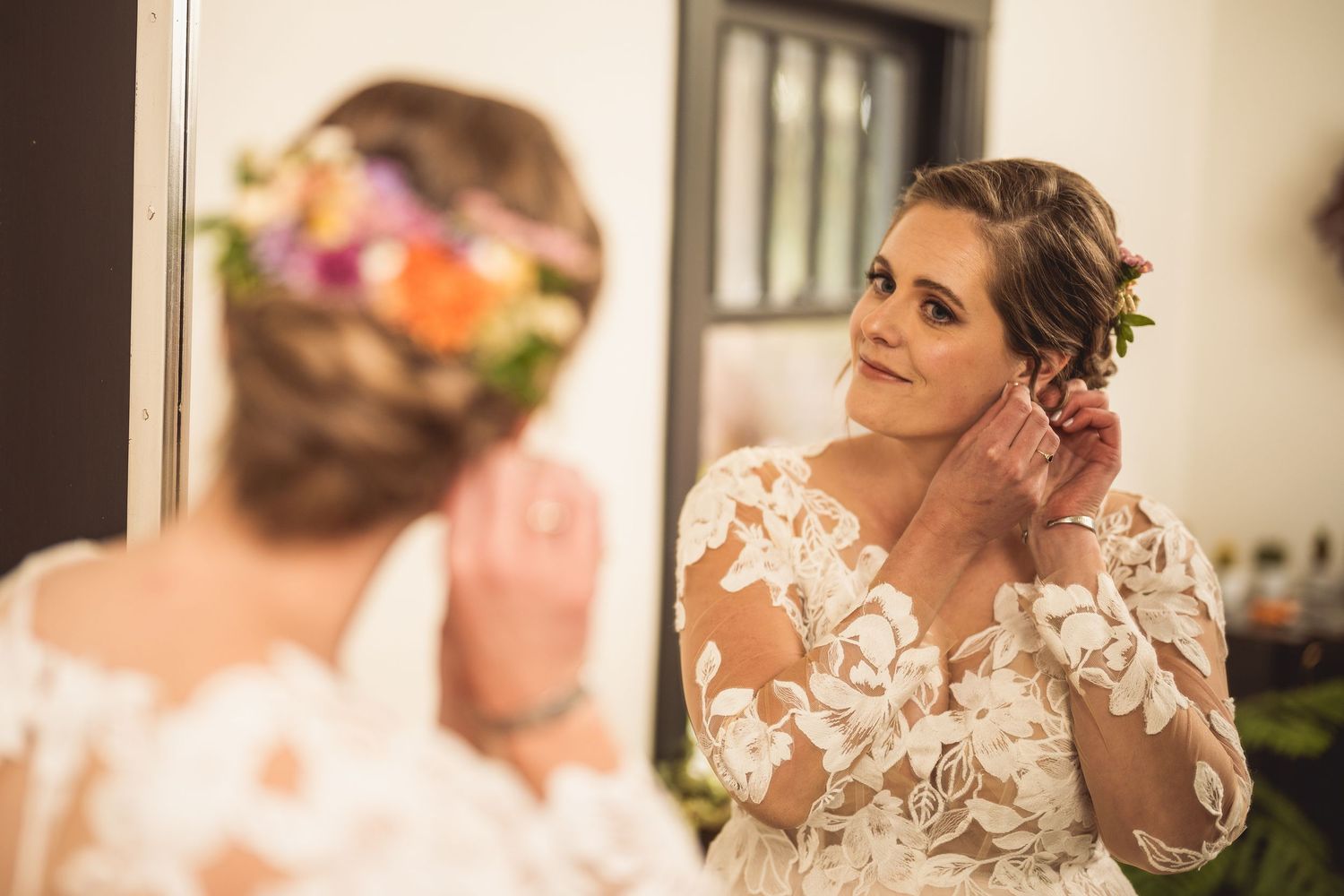 Close-up details of a wedding dress featuring delicate lace and floral embellishments.