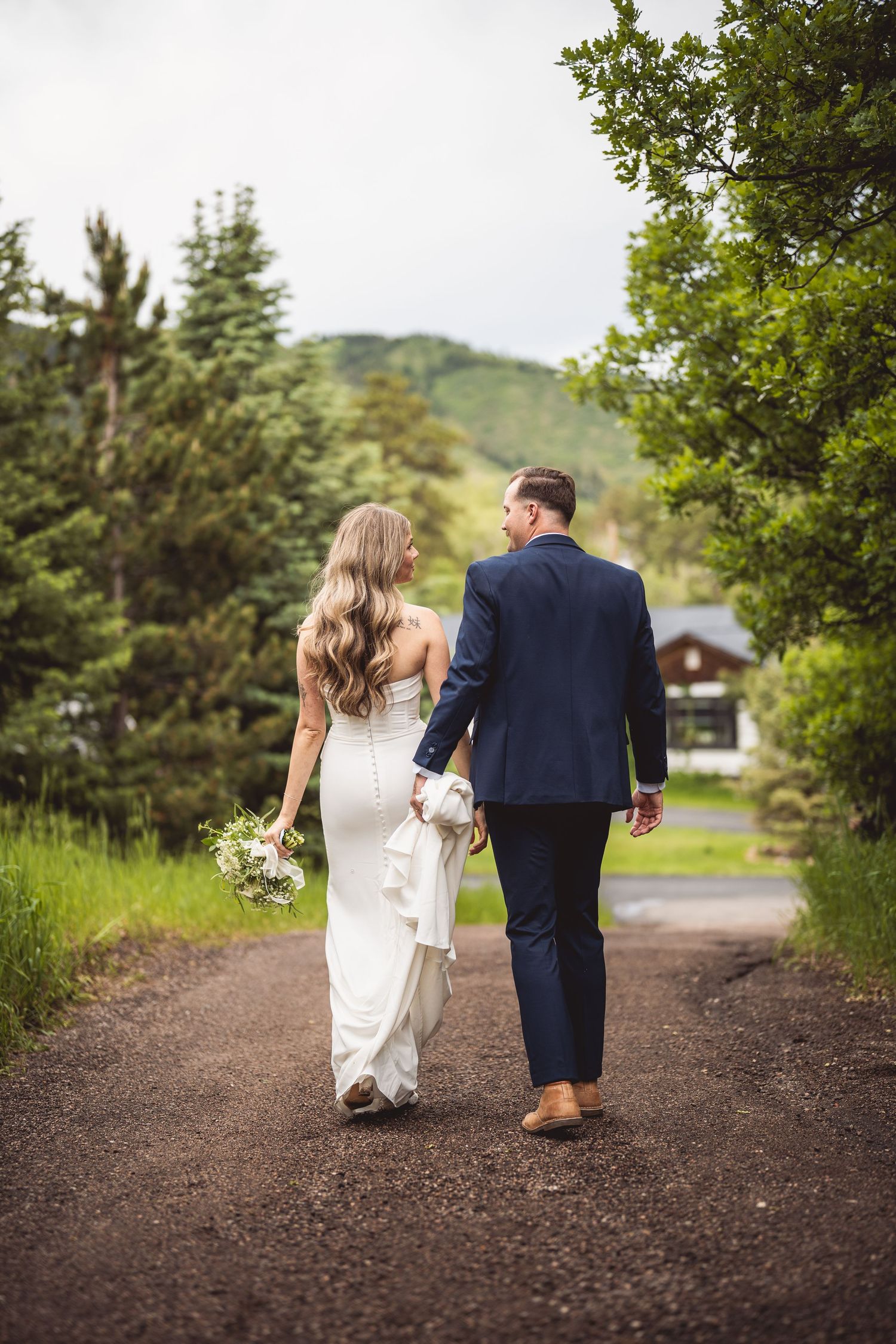 A series of candid walking shots of newlyweds on a tree-lined path.
