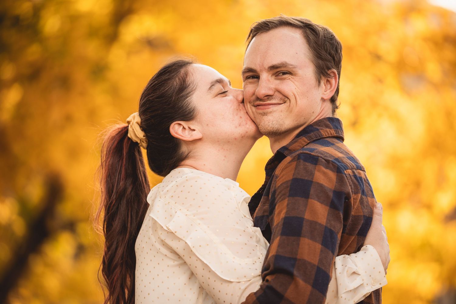 Intimate fall portrait session with warm golden lighting and autumn colors.