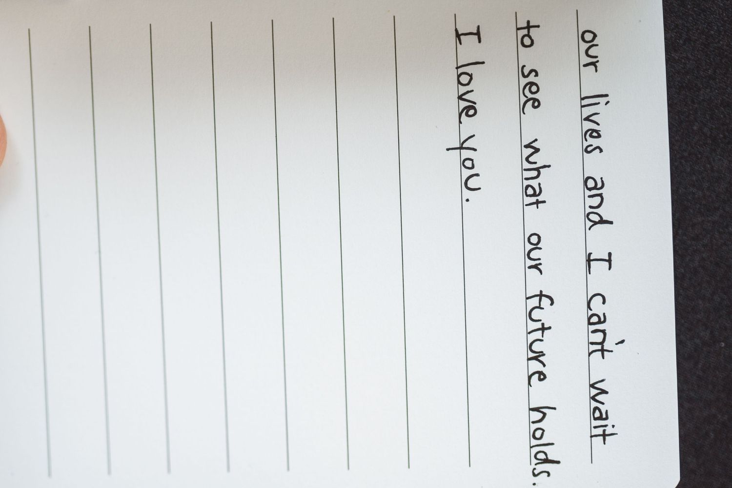 Close-up of handwritten text on lined notebook paper.