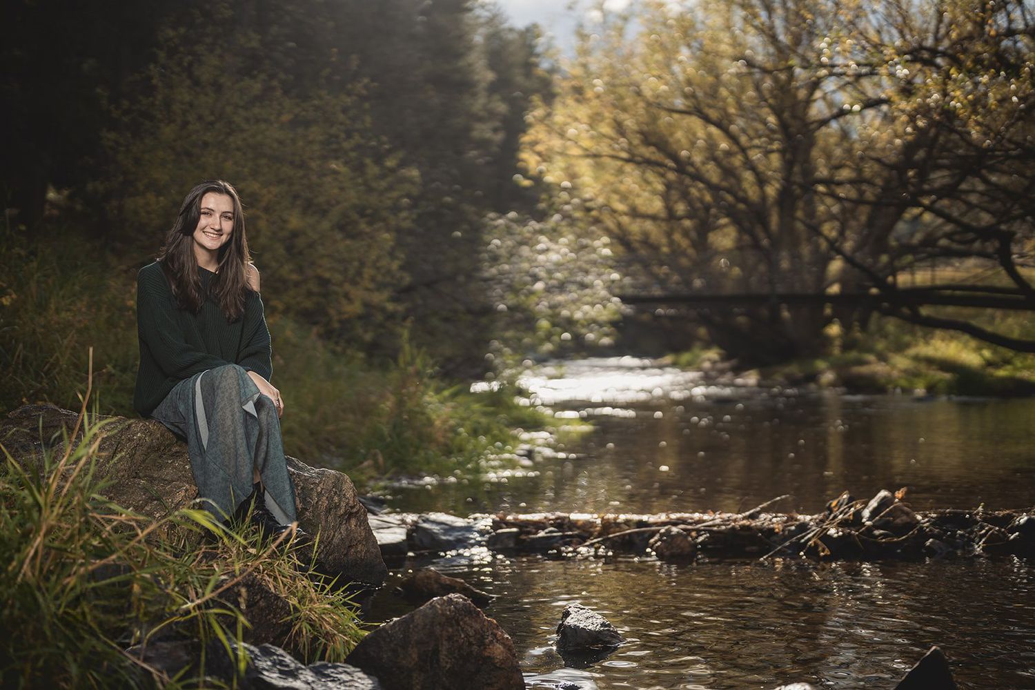 Scenic autumn landscape featuring a tranquil river surrounded by golden-leaved trees.