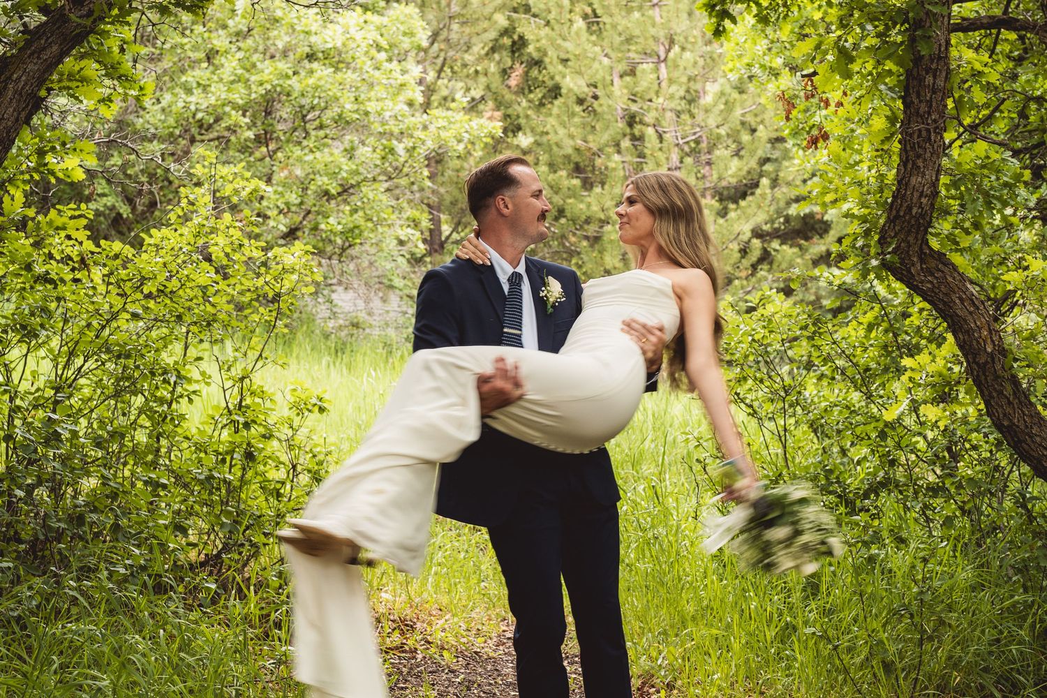 Playful wedding photography sequence in a lush forest setting.