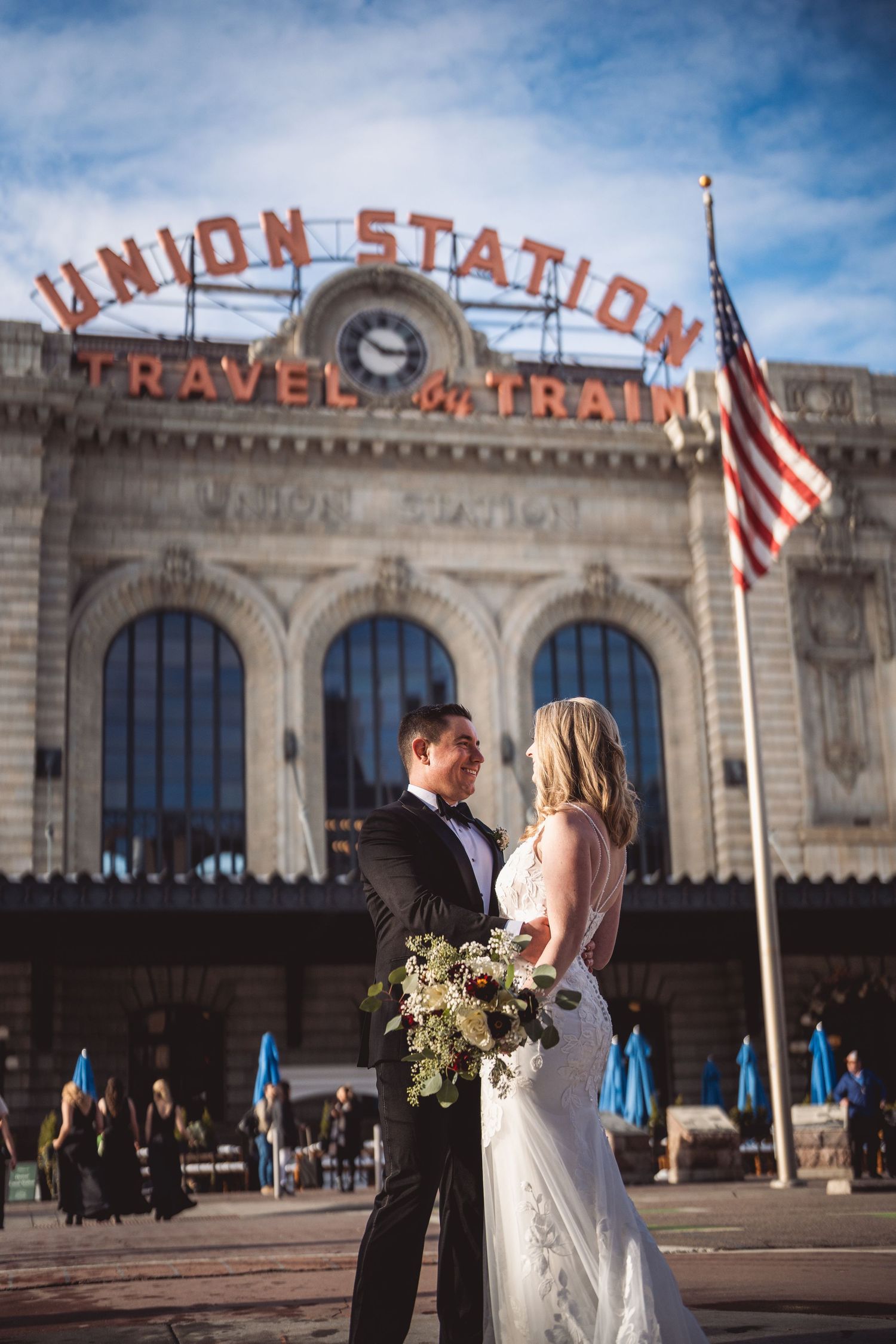Wedding photos taken in front of historic Union Station building with classic architecture.