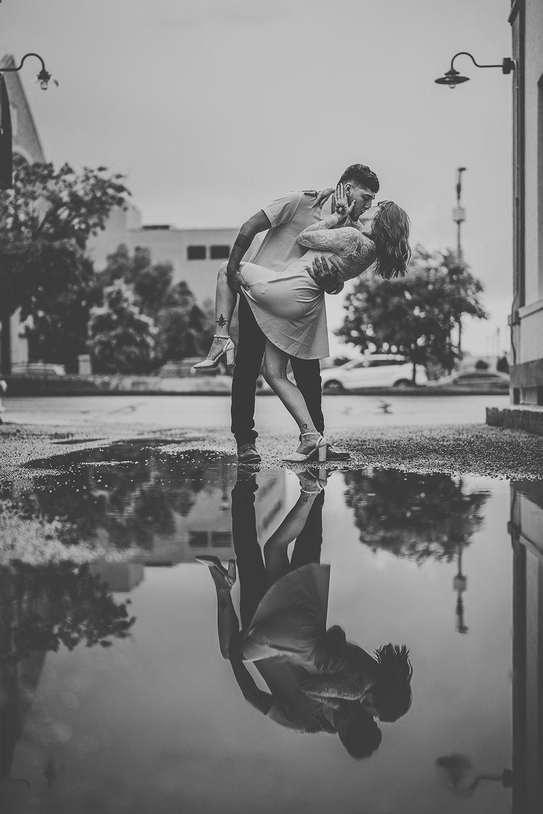 Creative reflection photography in rain puddles on urban pavement.