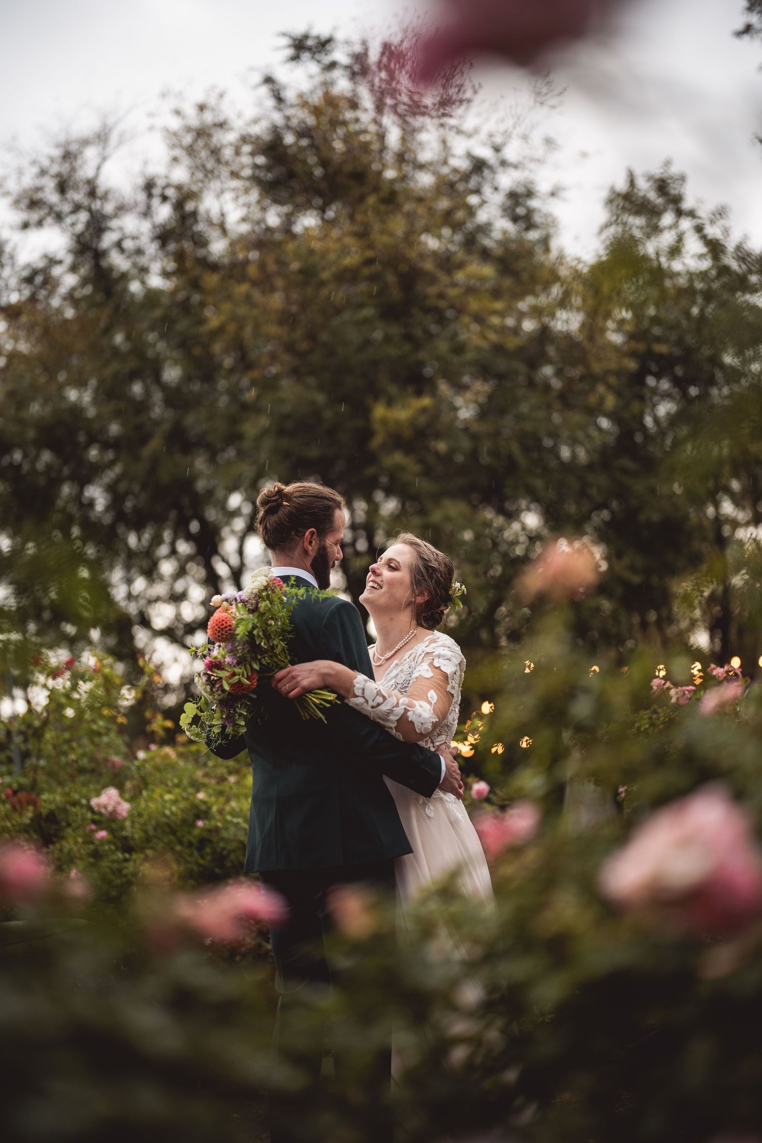 A romantic wedding moment captured in a rose garden with soft bokeh and natural lighting.