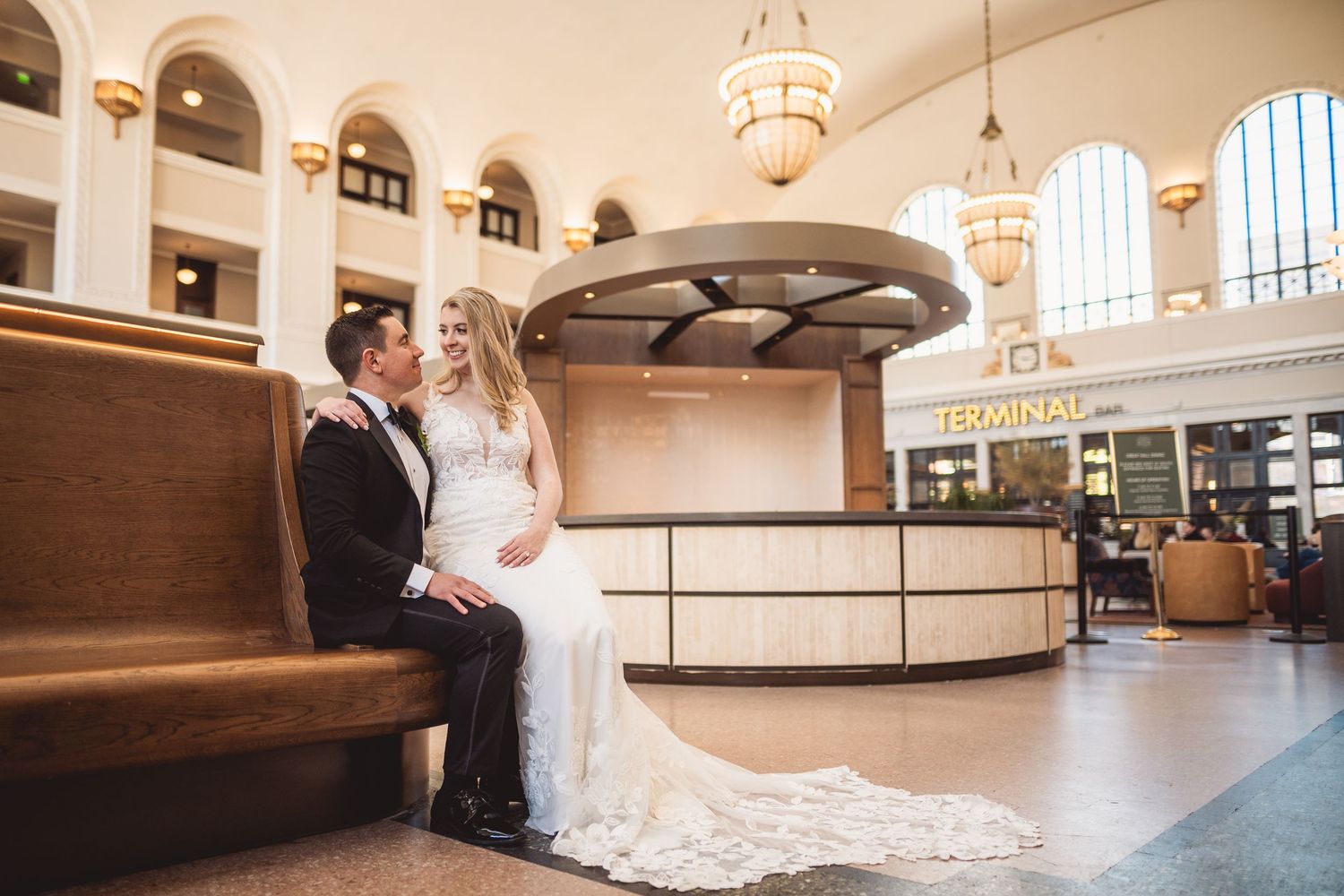 Union Station's ornate interior with classic architecture and chandeliers during a wedding.