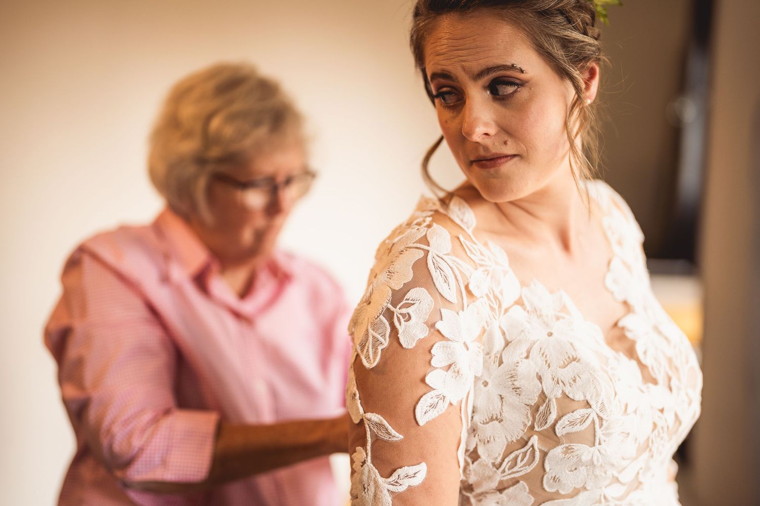 Soft focus wedding preparation moment captured in warm natural light.