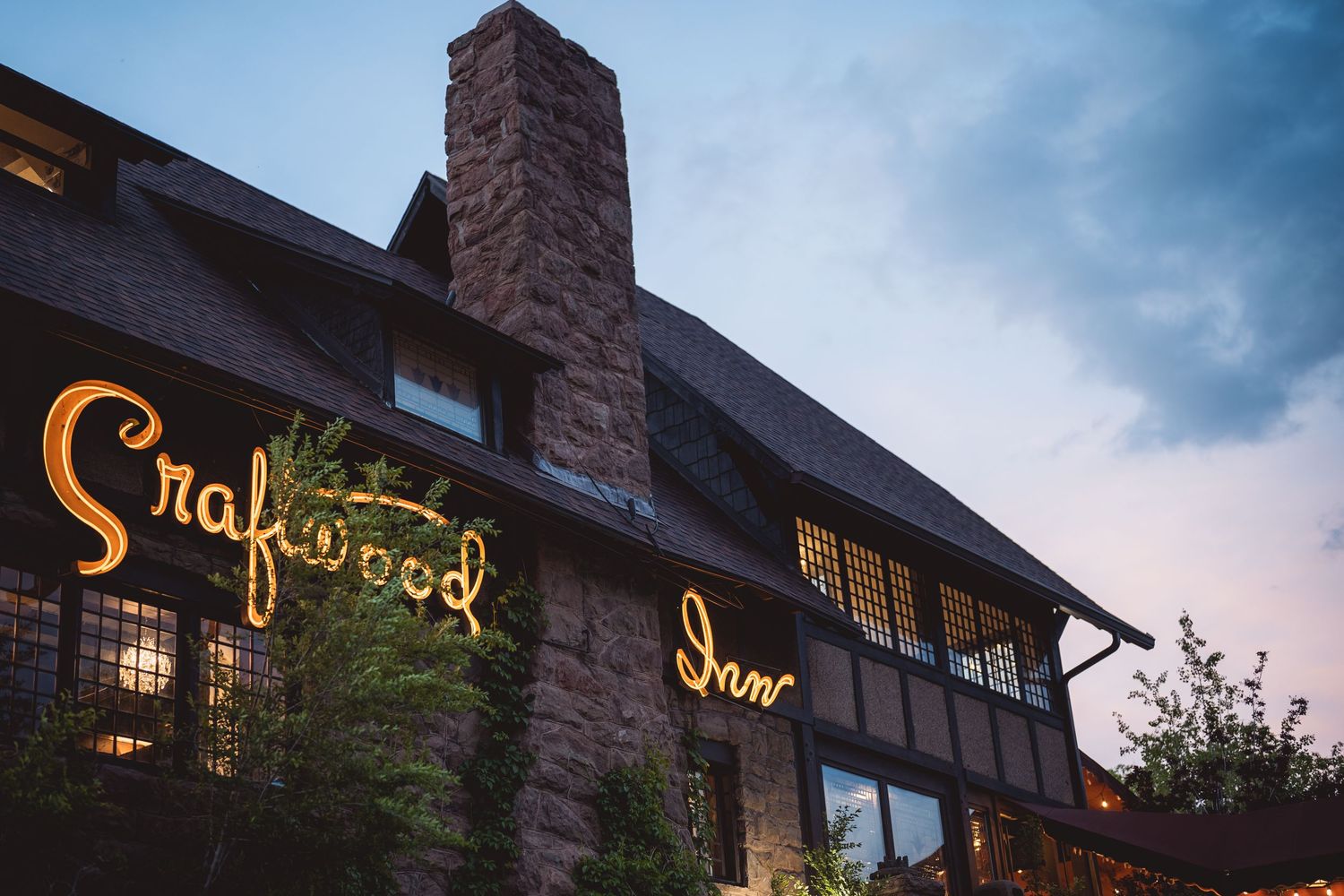 Exterior view of Snuffers restaurant with illuminated signage at dusk.