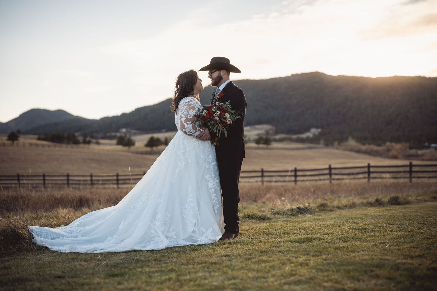 Romantic wedding portraits at sunset in mountain landscape with flowing dress.