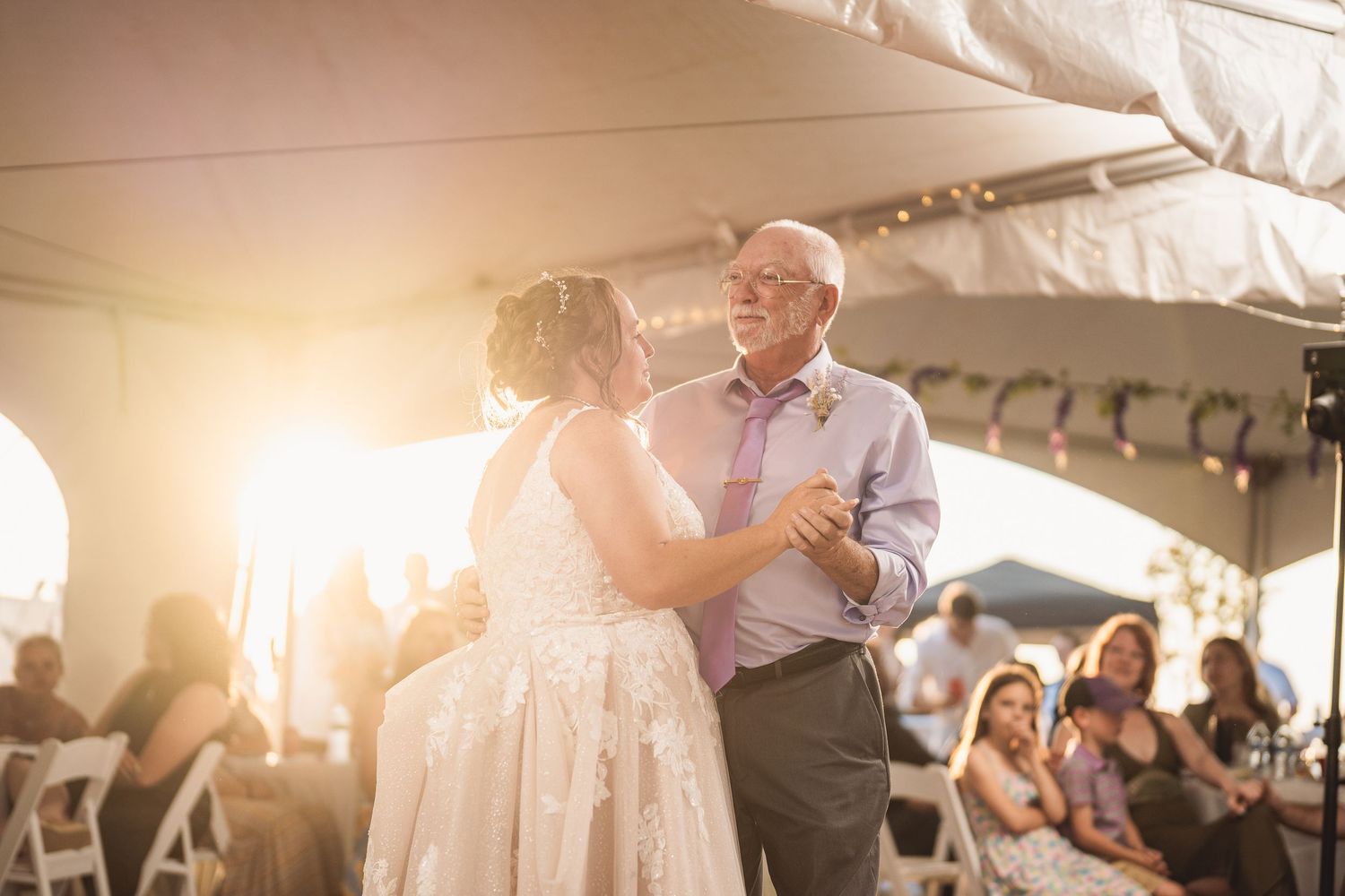 Couples dancing during a romantic wedding reception with warm lighting and festive atmosphere.