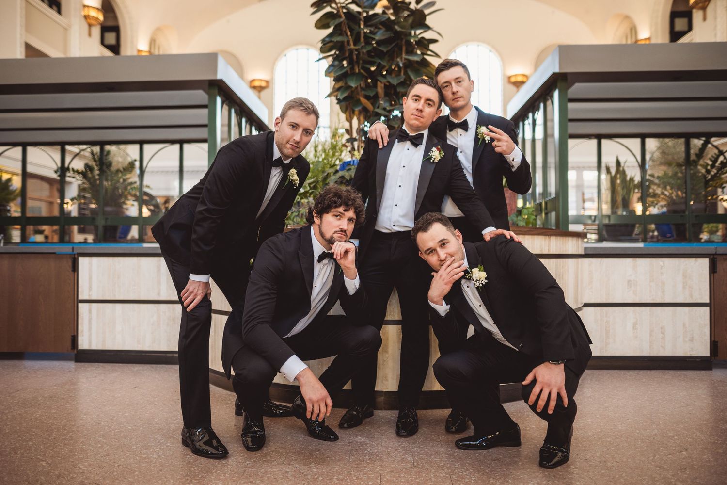 Wedding party poses together in formal attire at Union Station.