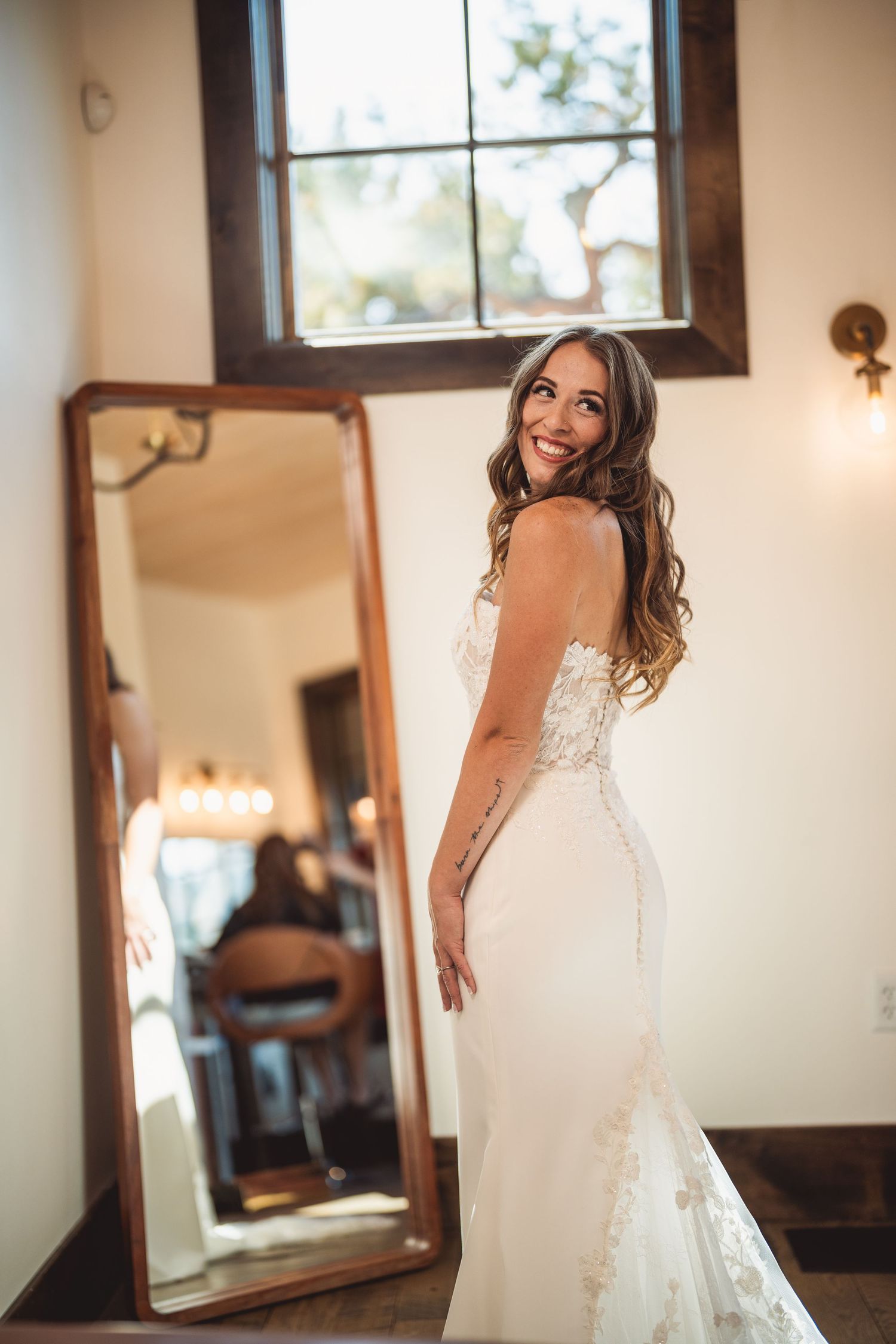 Elegant wedding dress details captured in natural window light.