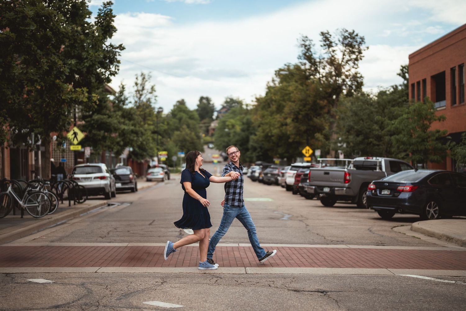 Series of playful poses captured on urban street with crosswalk signals.