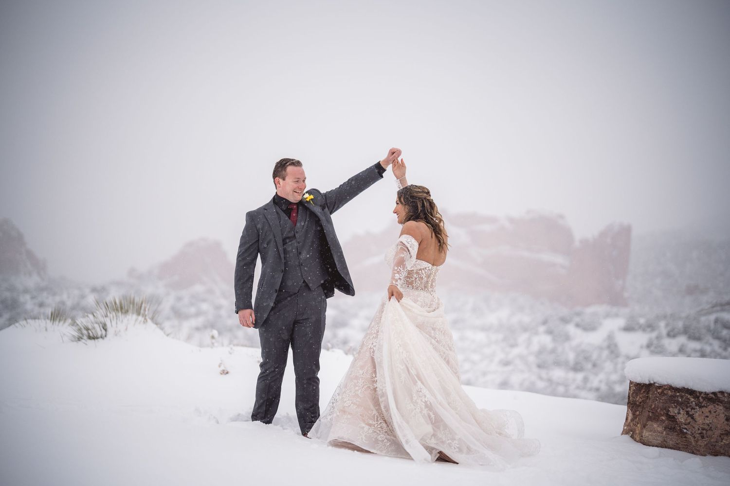 A romantic photoshoot in the snow with a couple in wedding attire.