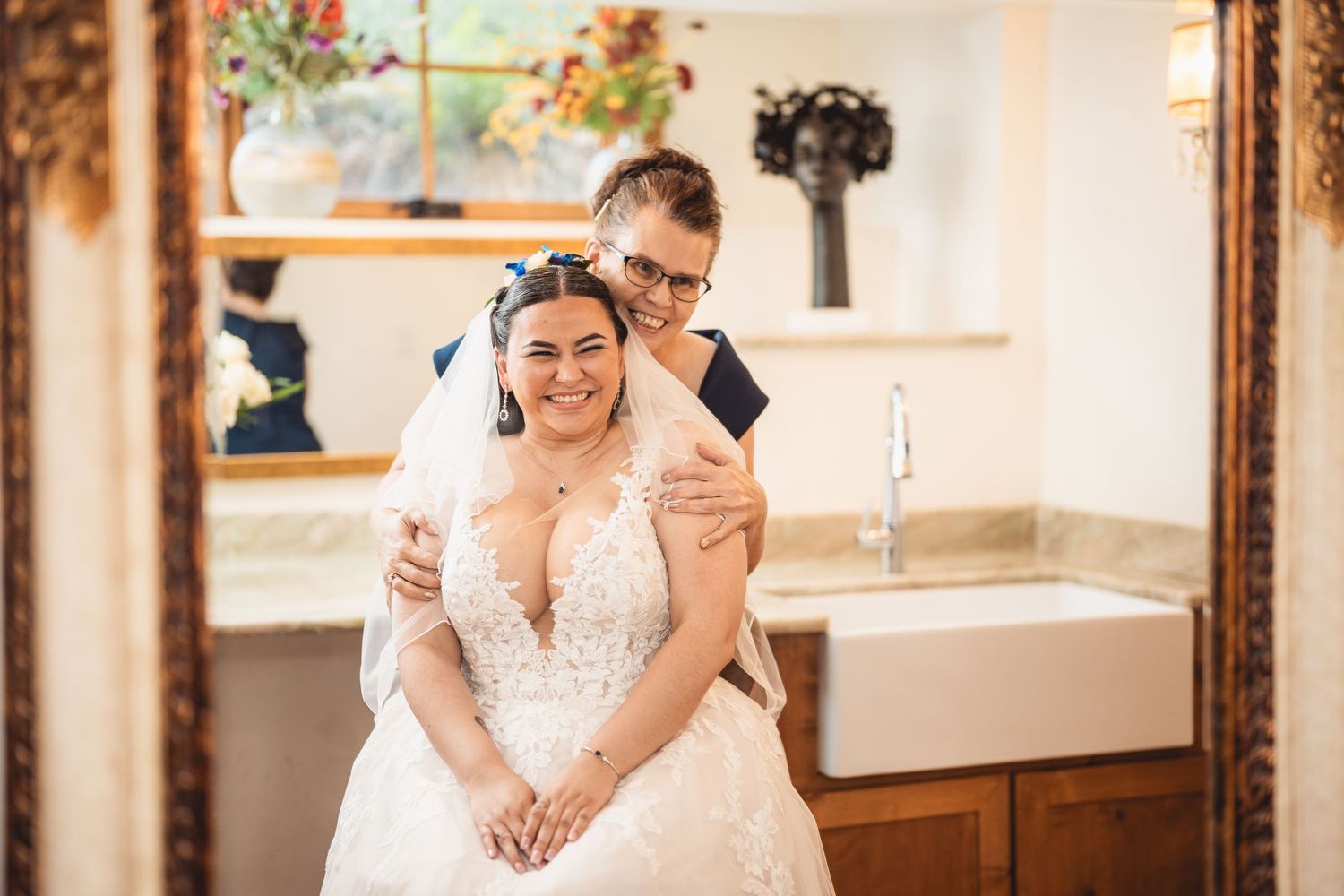 An intimate indoor wedding portrait with elegant decor and mirrors.