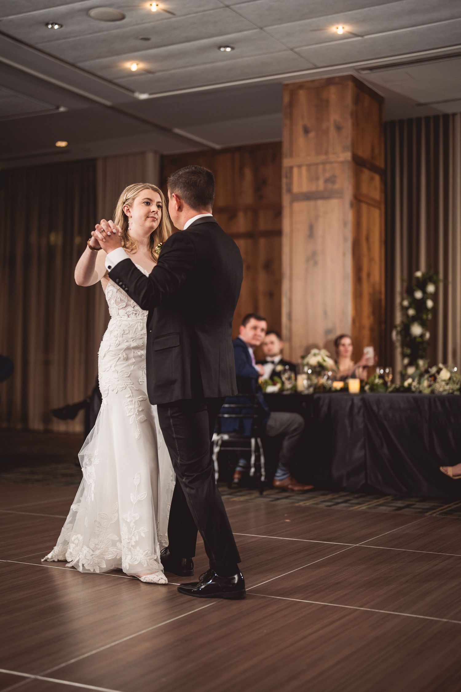 Wedding couple performs romantic dance in an elegant modern reception venue.
