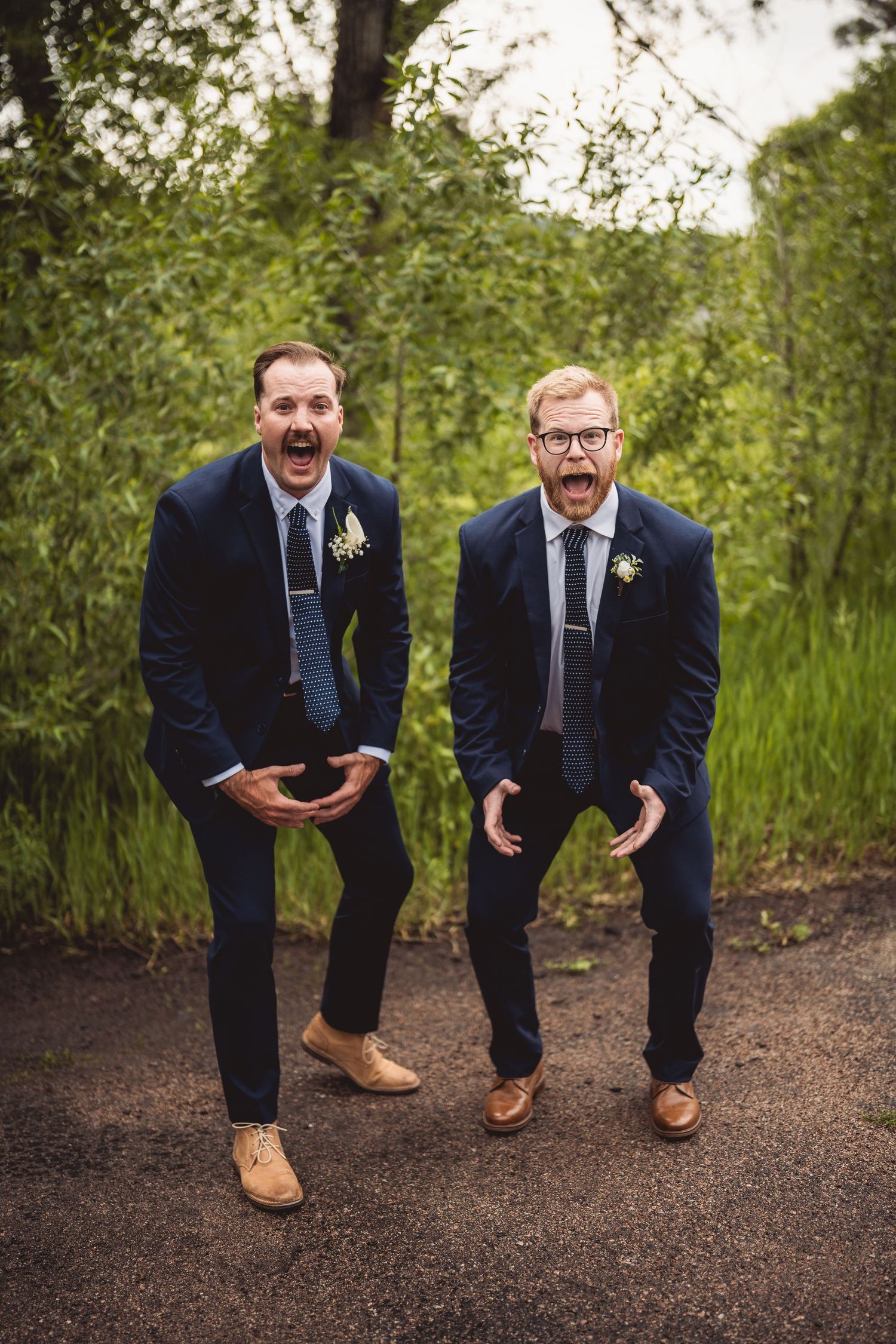 Series of playful interactions between two people in suits on outdoor path.